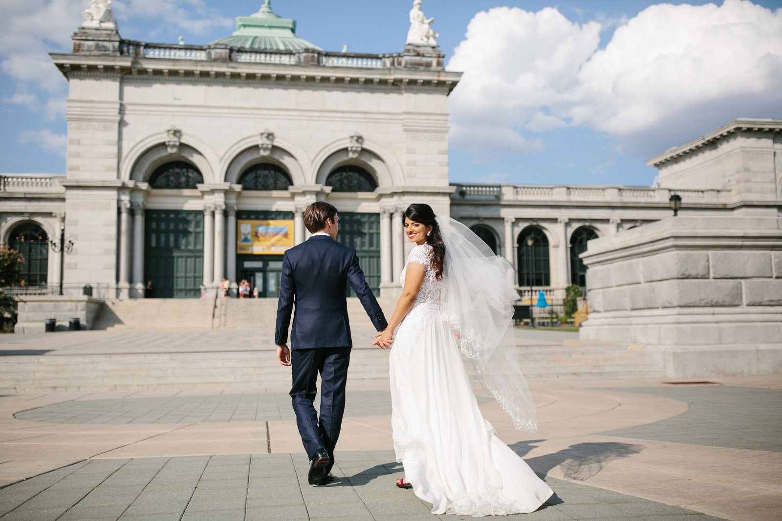 Newly wed couple walking into their wedding reception at Please Touch Museum in Philadelphia, PA.