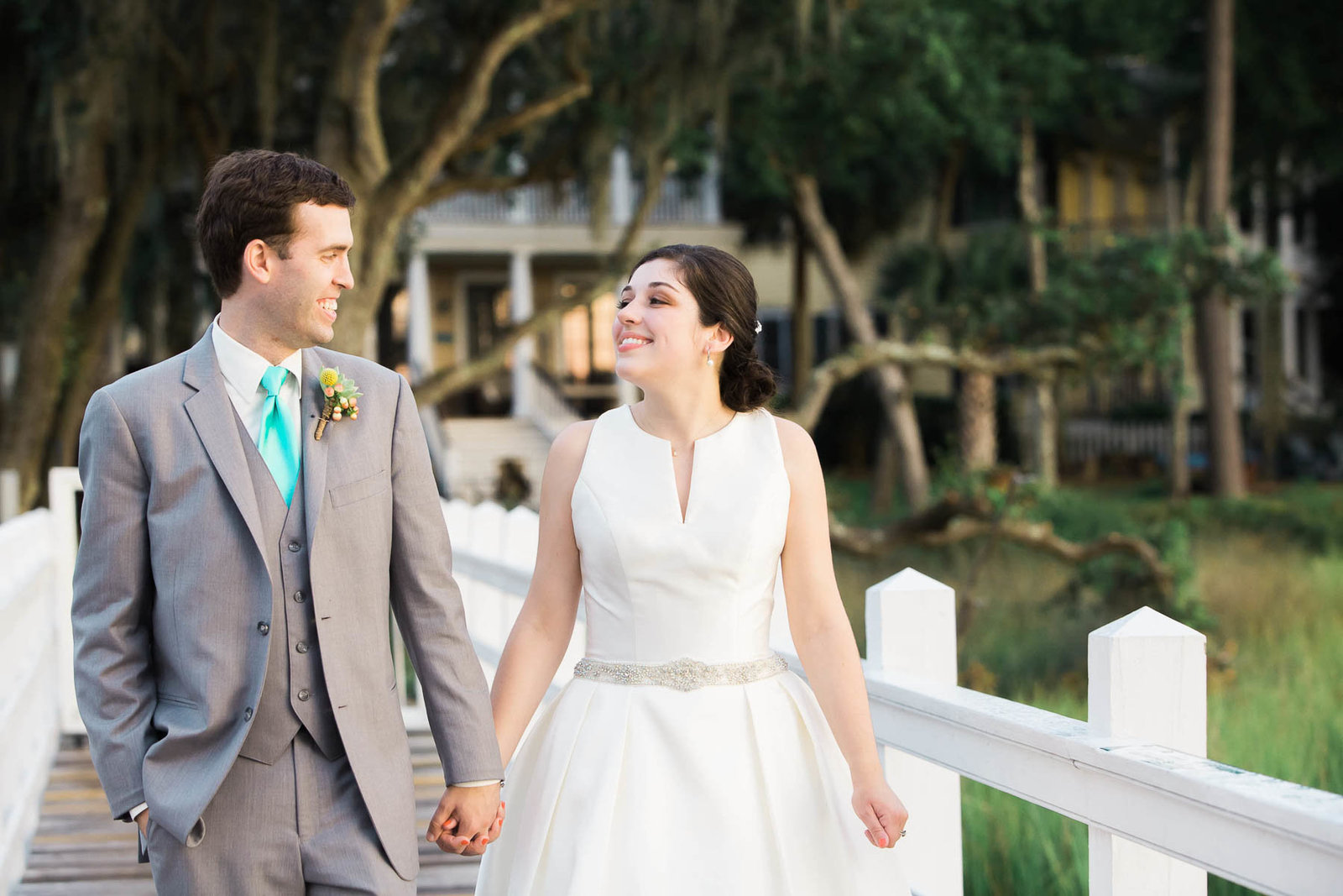 Bride and groom stand on dock, I'on Creek Club, Mt Pleasant, South Carolina