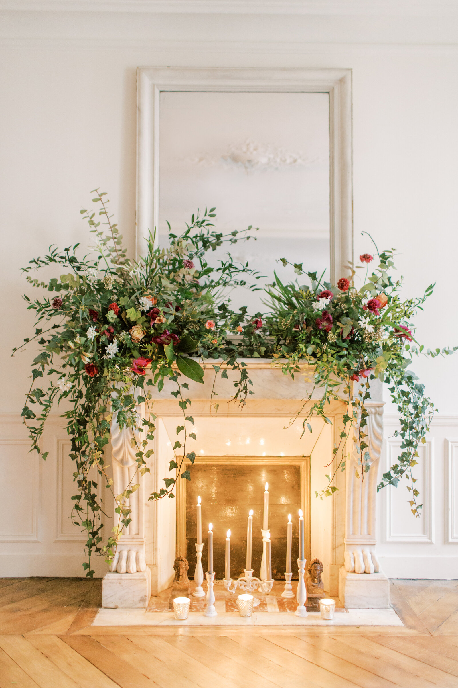 fireplace mantel with candles and flowers