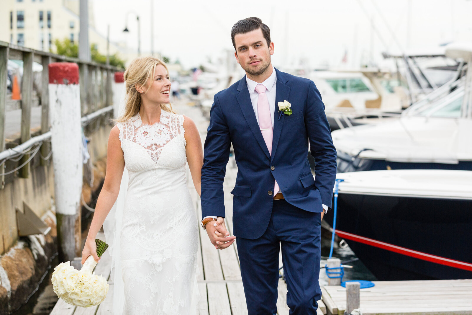 bride and groom walking in newport marina