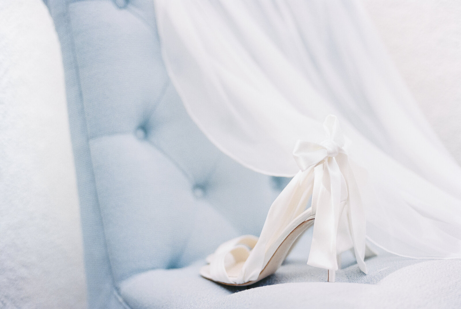 Bella belle wedding shoes on french blue chair with veil at Cottage at Riverbend Wedding by the Best Boise Wedding Photographers
