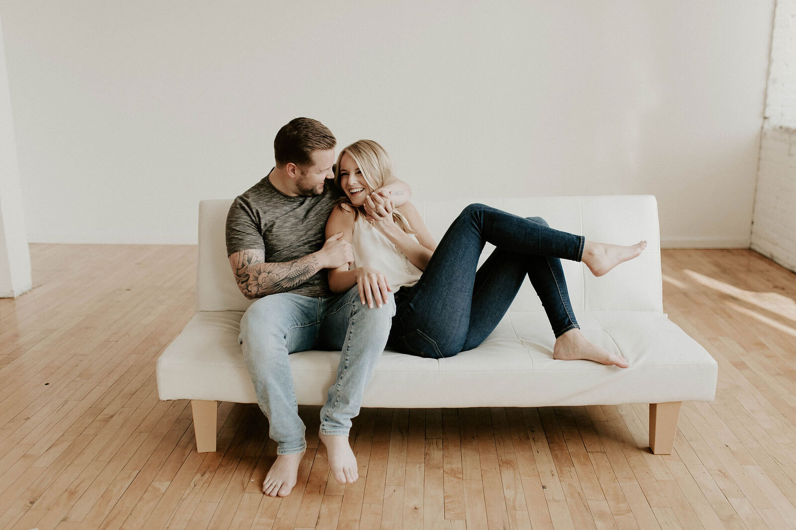 Couple sitting on a couch cuddling