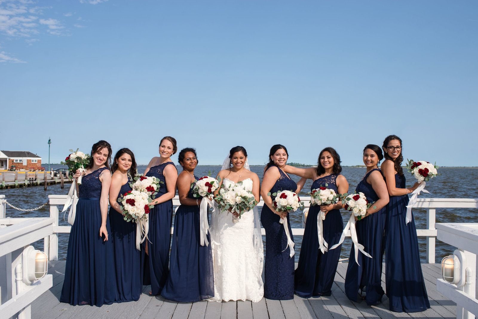 Bride and bridesmaids on dock