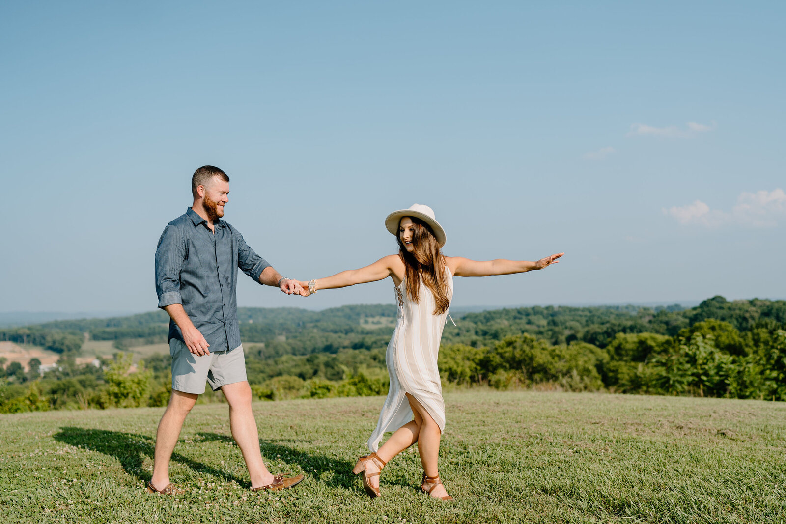 couple holding hands on top of mountain in spring hill, tennessee