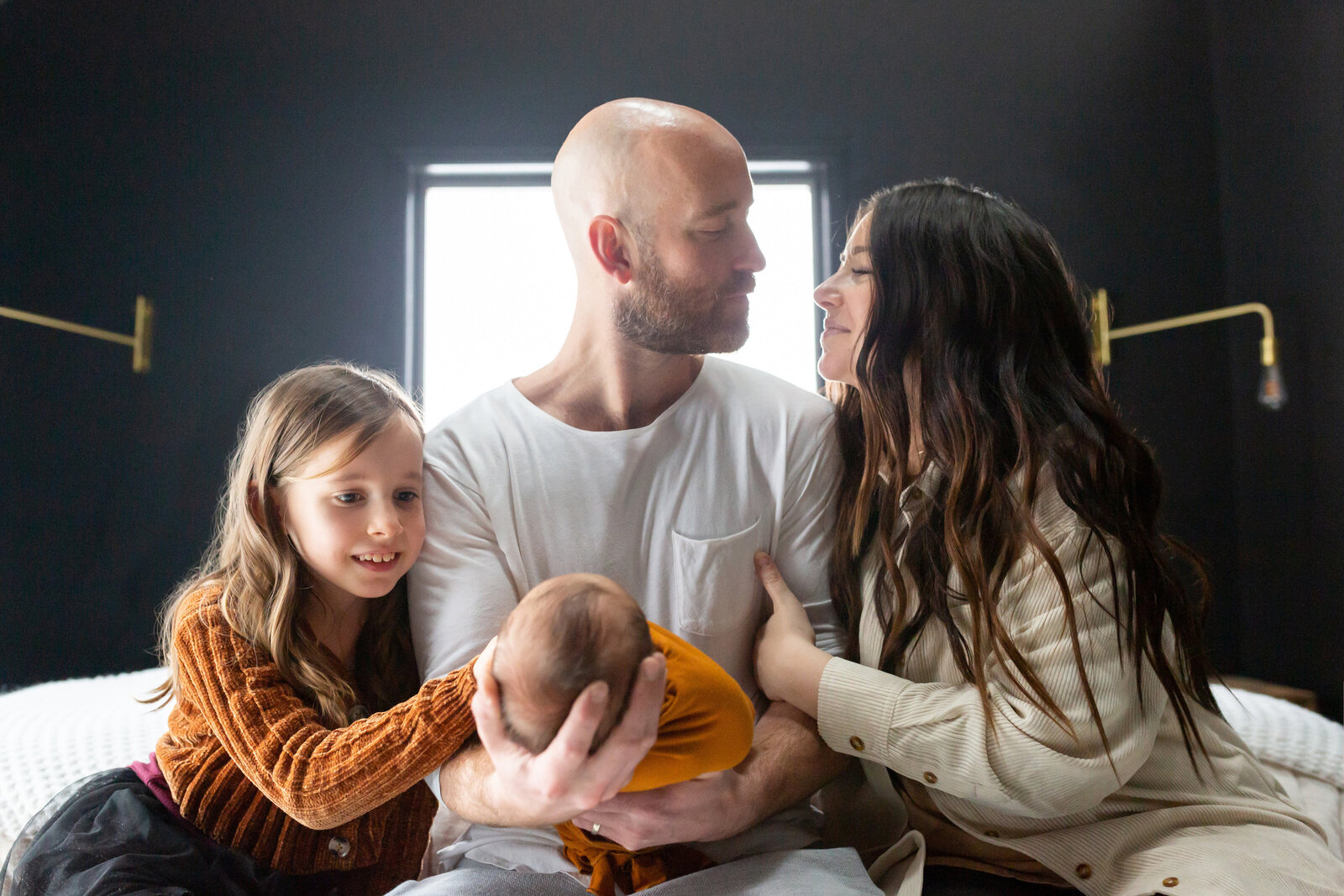 Family on bed with toddler and newborn - lifestyle newborn session - Jen Madigan Photography