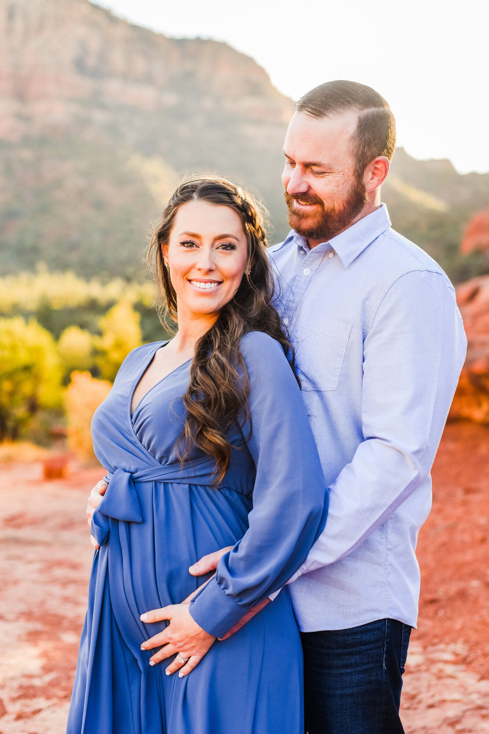 Sedona couple holding belly pregnant pregnancy announcement red rocks