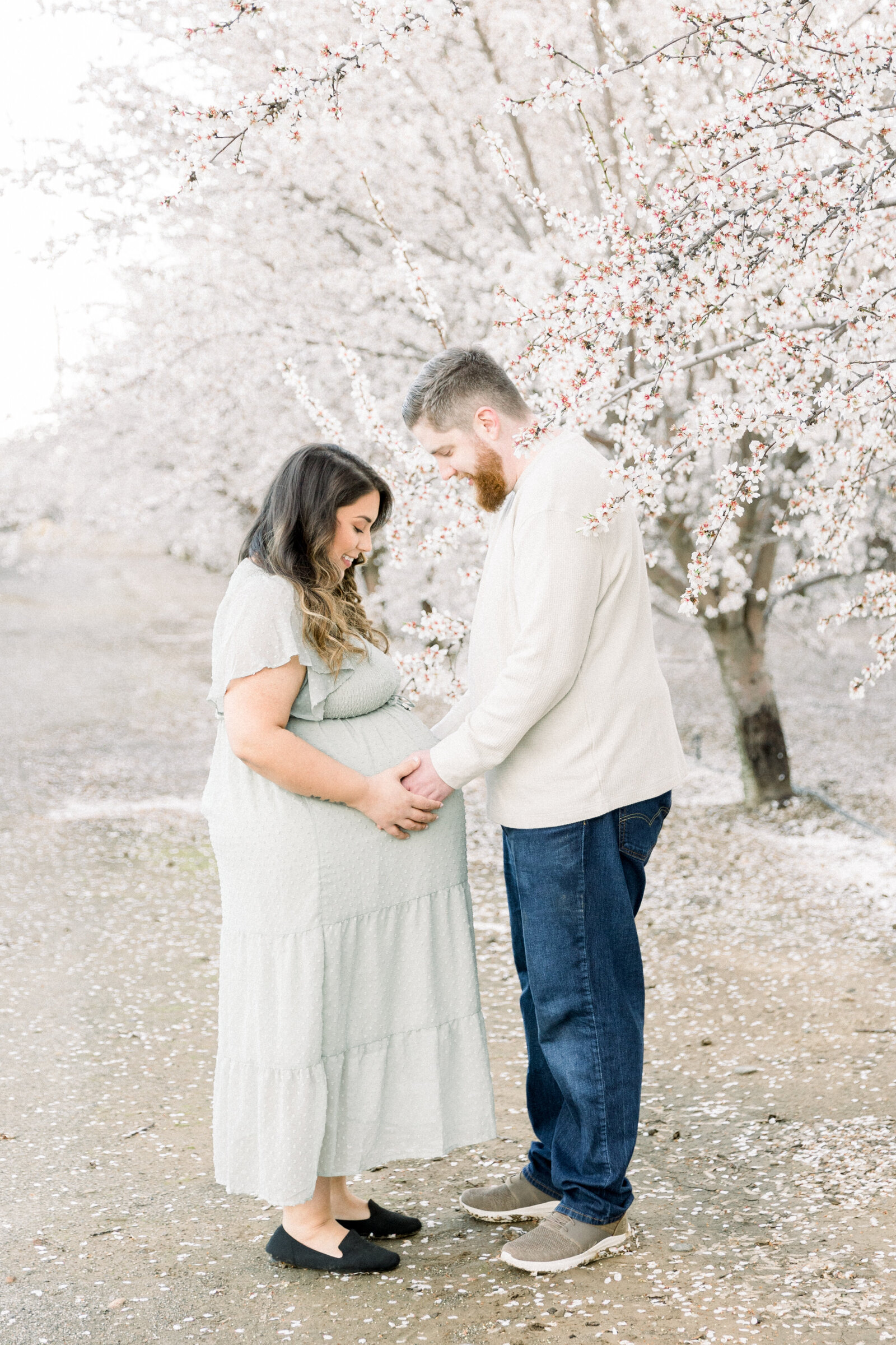 Image of expecting parents holding baby bump taken by Sacramento Newborn Photographer Kelsey Krall