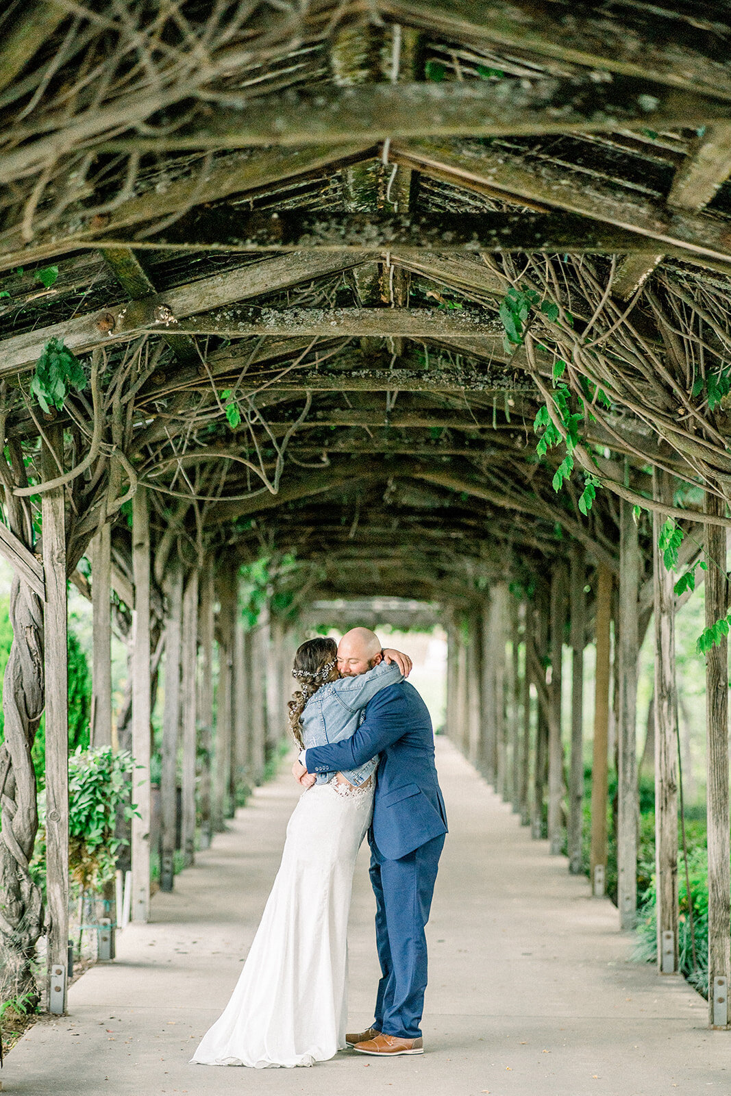 Bride and groom hug under the vines at Filoli in Woodside, CA