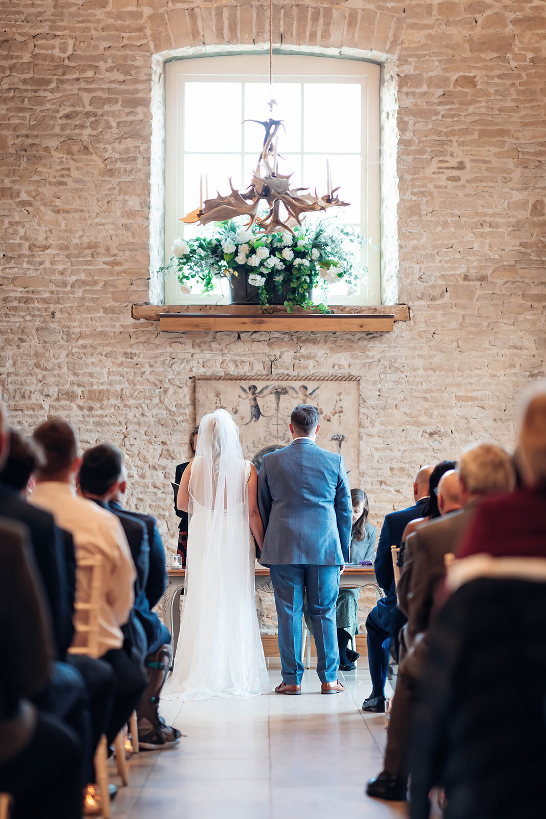 couple-stood-at-end-of-aisle-during-wedding-ceremony-at-merriscourt