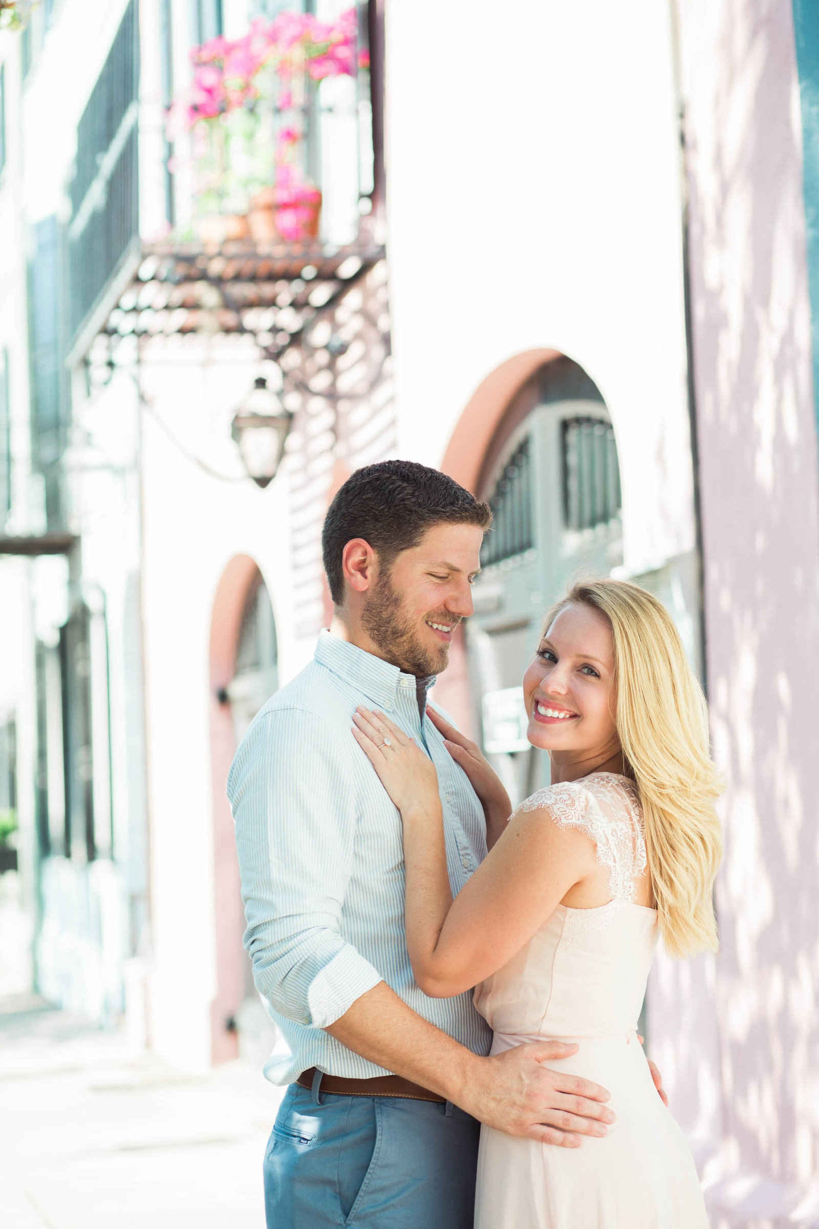 Engaged couple pose by Rainbow Row, Downtown Charleston, South Carolina