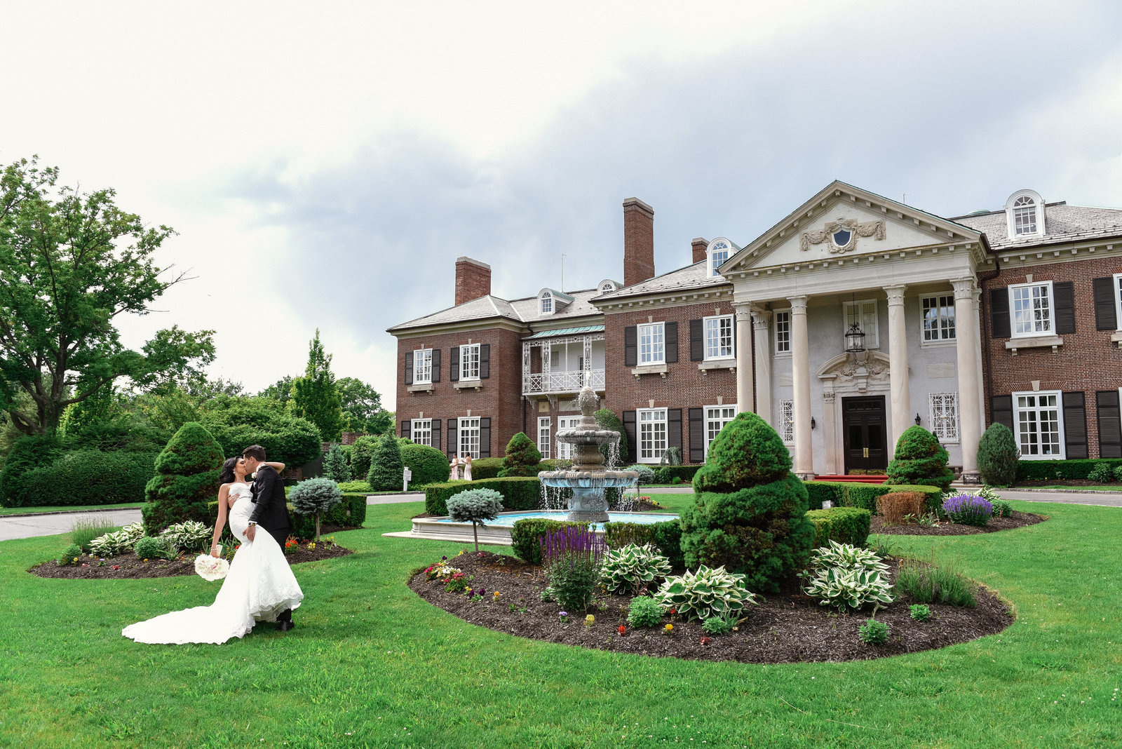 Bride and groom kissing at Glen Cove Mansion