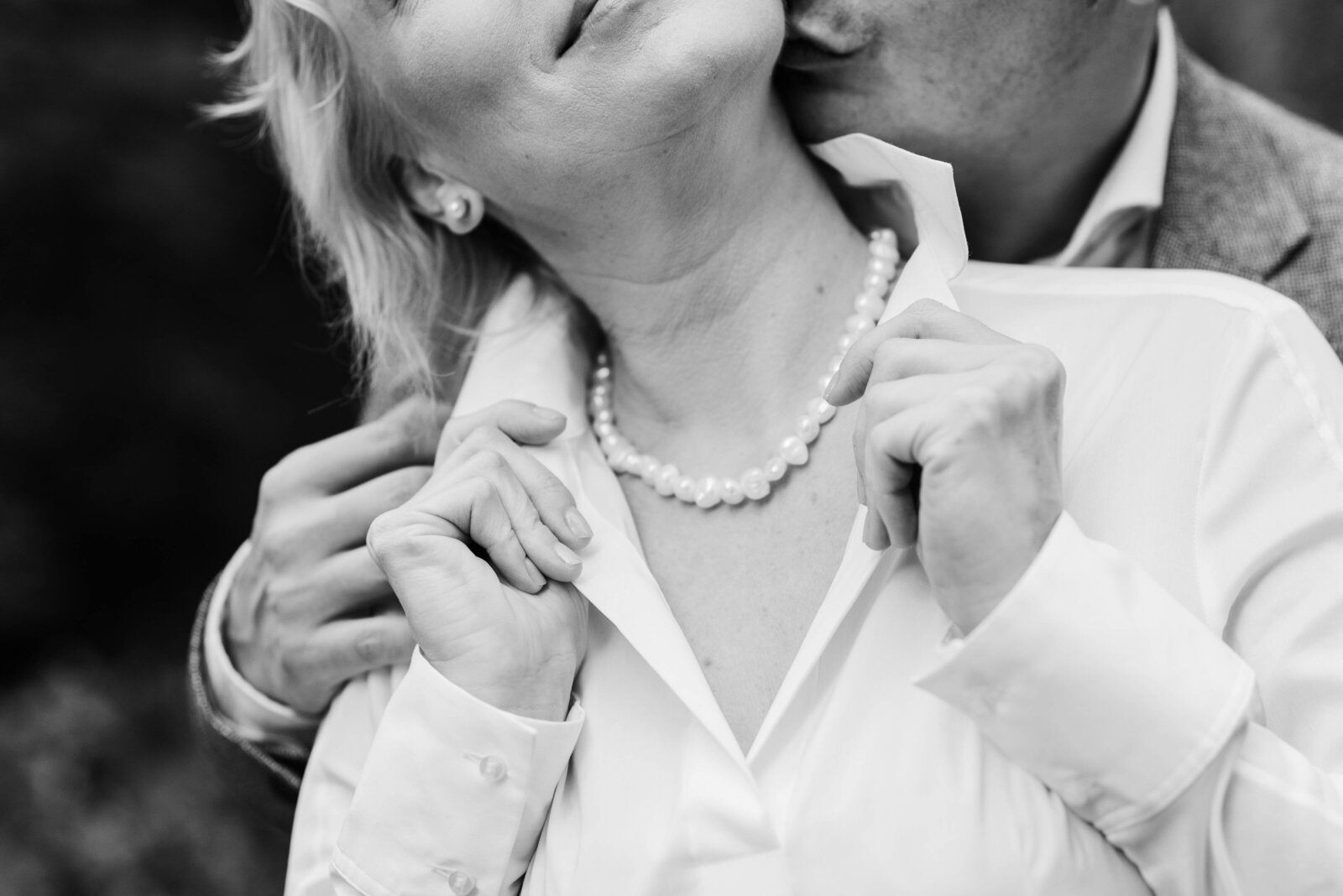 Detail shot of husband kissing wife from behind