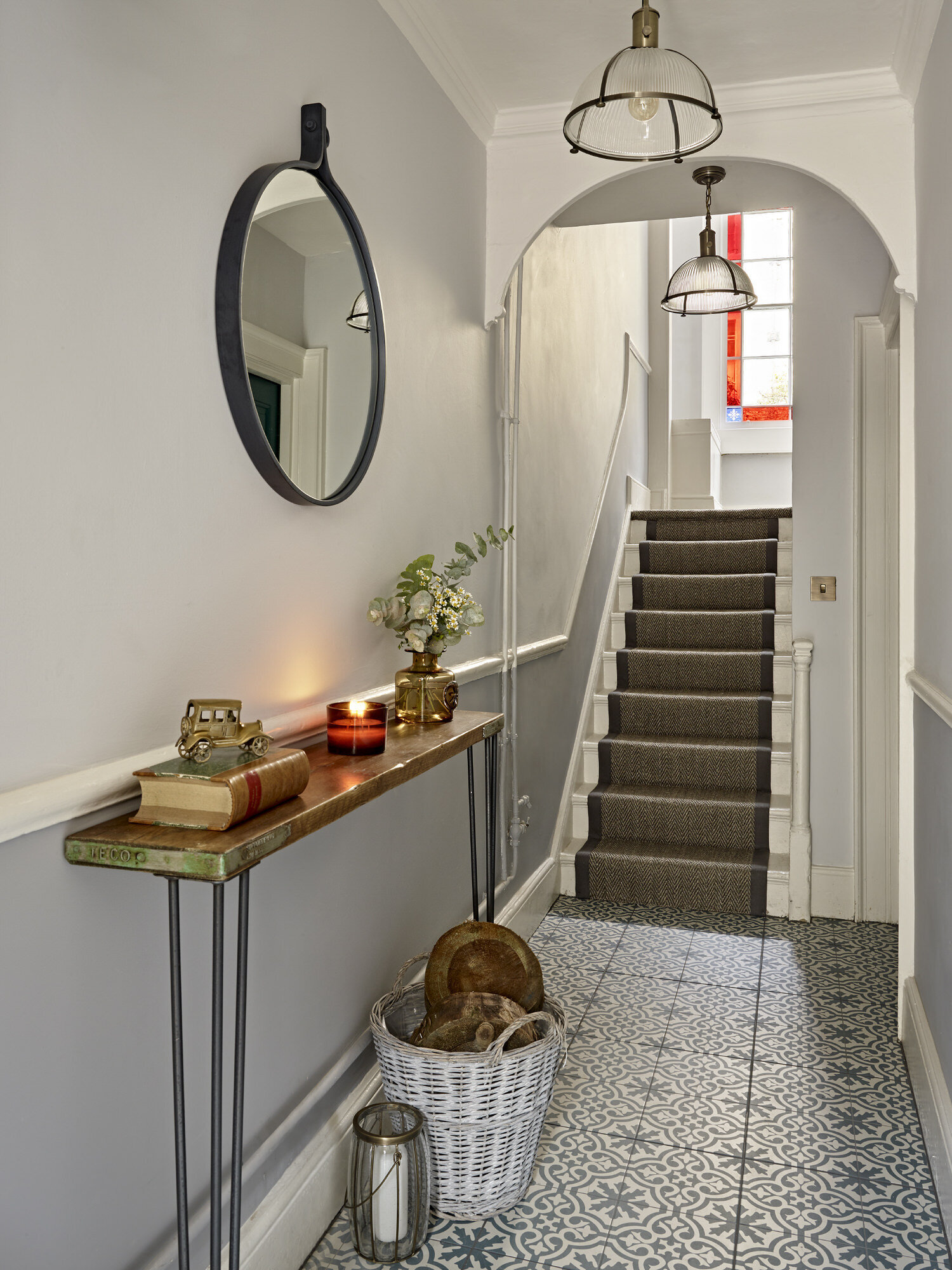UK apartment hall with patterned tile and staircase