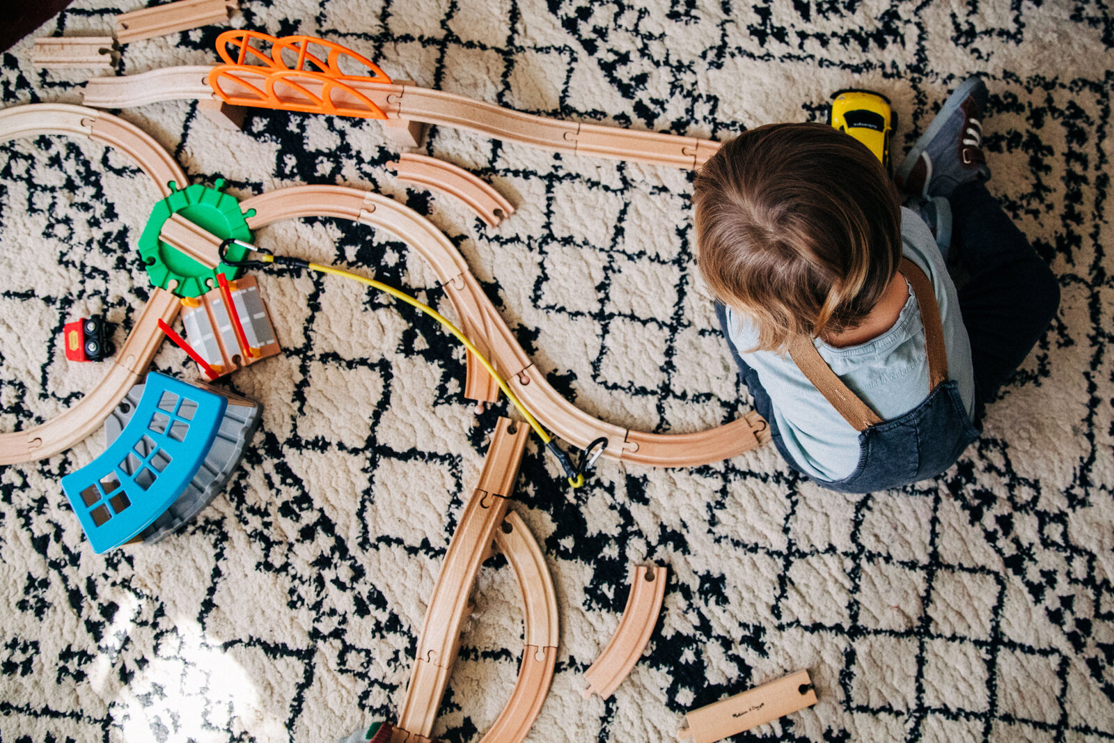 overhead view of toddler playing with trains