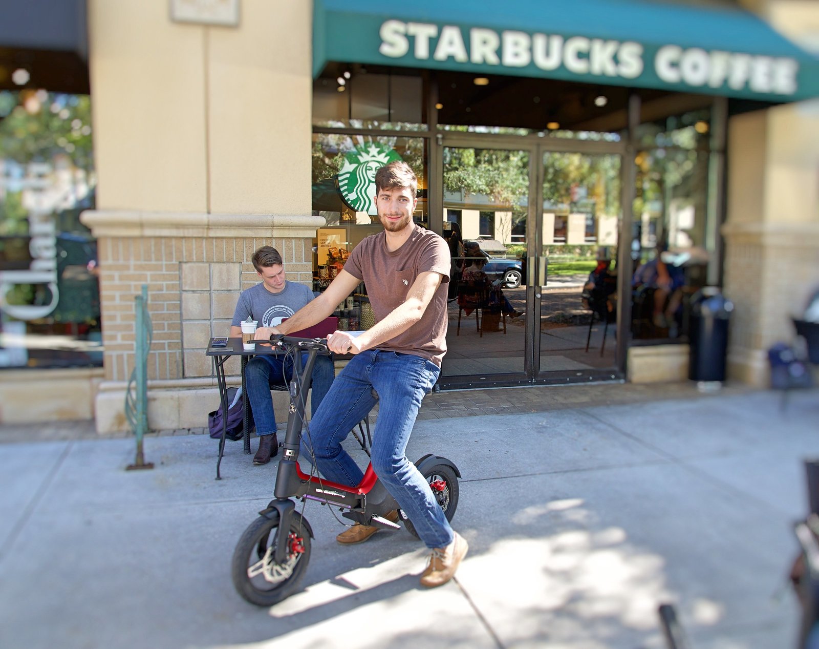 Student riding Red Go-Bike M3 to Starbucks Coffee