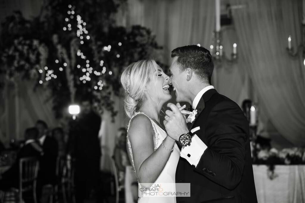 Bride and groom laugh during their first dance