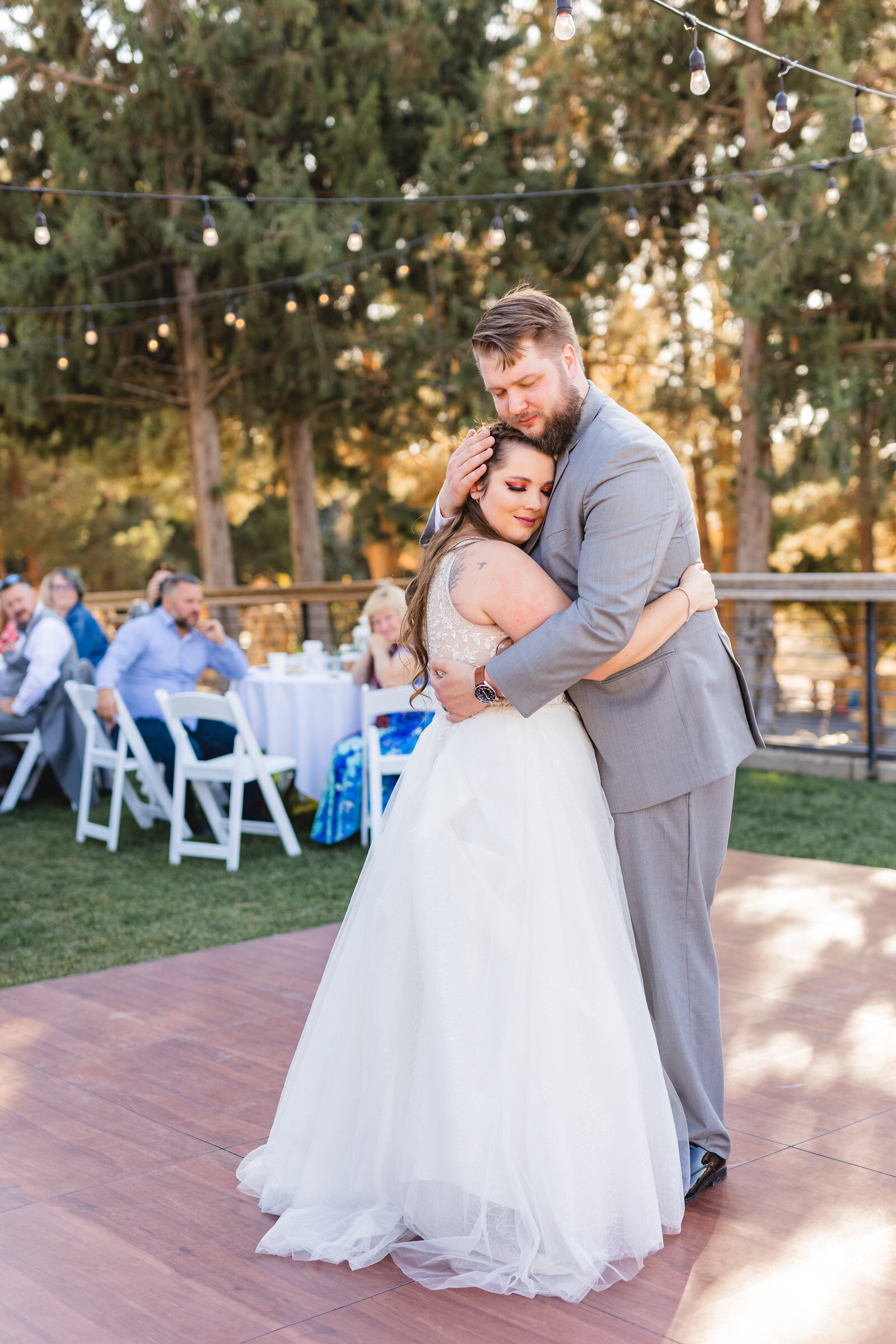 bride and groom during first dance on outdoor dance floor