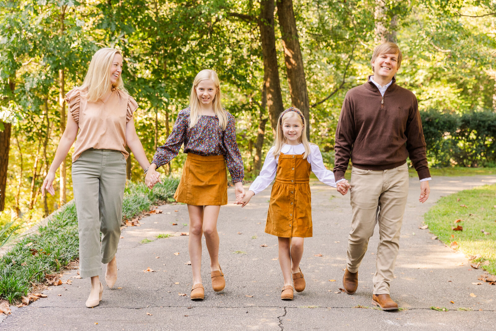 family holding hands walking in a park in Atlanta Laure photography