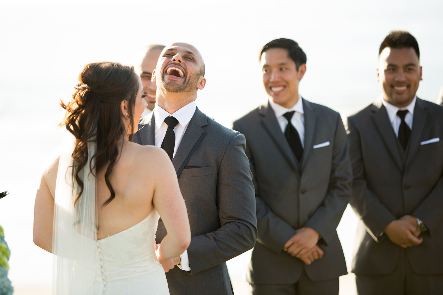 groom laughing at ceremony