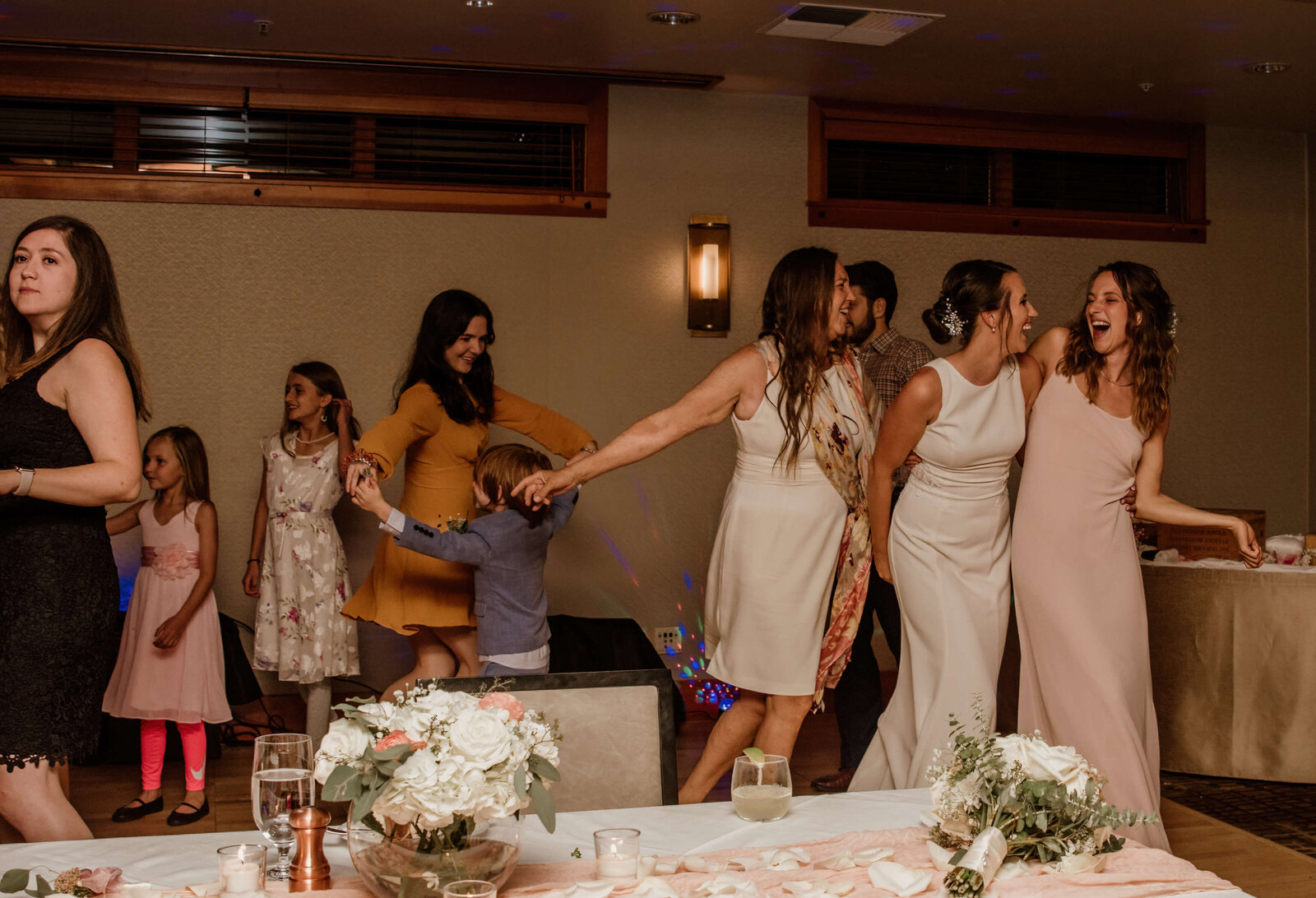Bride and her Mom and sister dancing.