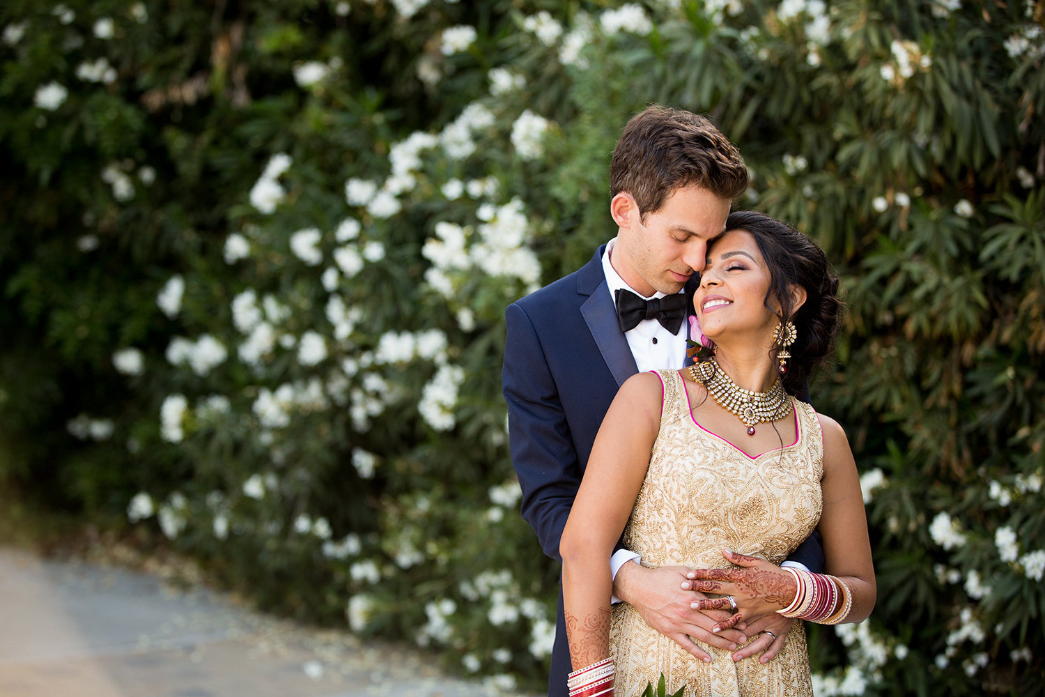 Loving embrace of Indian bride and groom at Twin Oaks Wedding Estate in San Diego