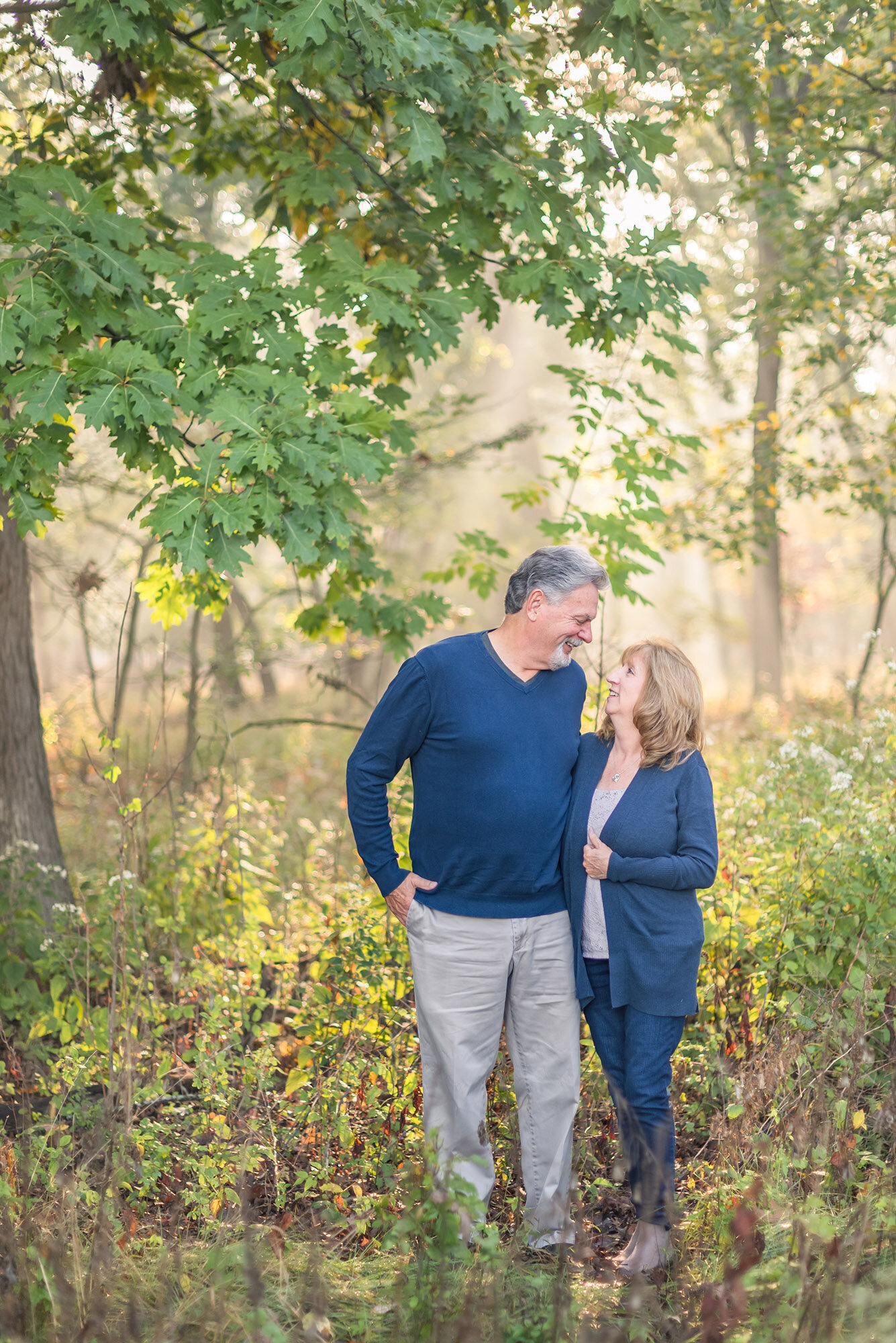 Portrait of two grandparents in the fall woods