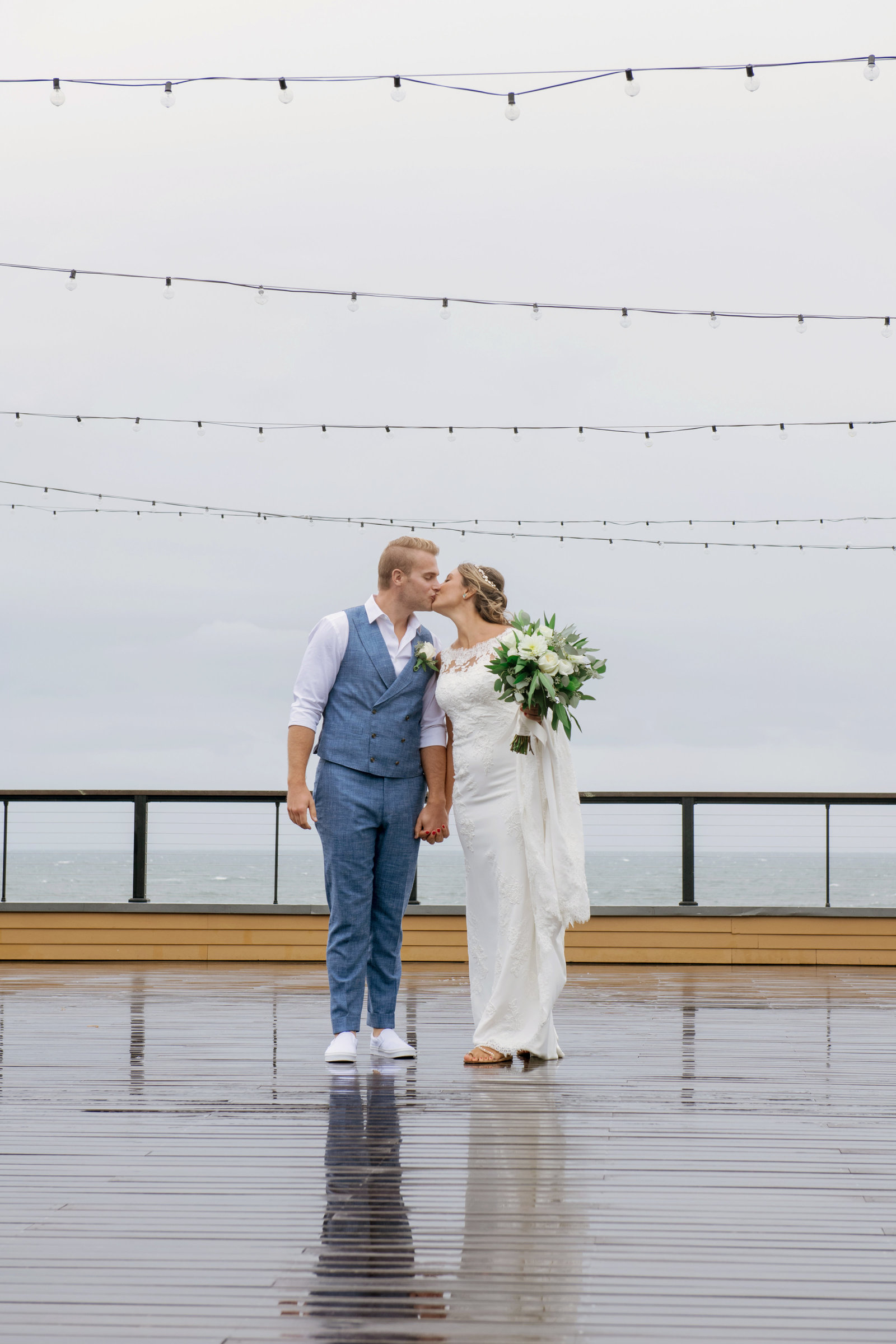 bride and groom kissing on the boardwalk deck at Gurneys Montauk Resort wedding