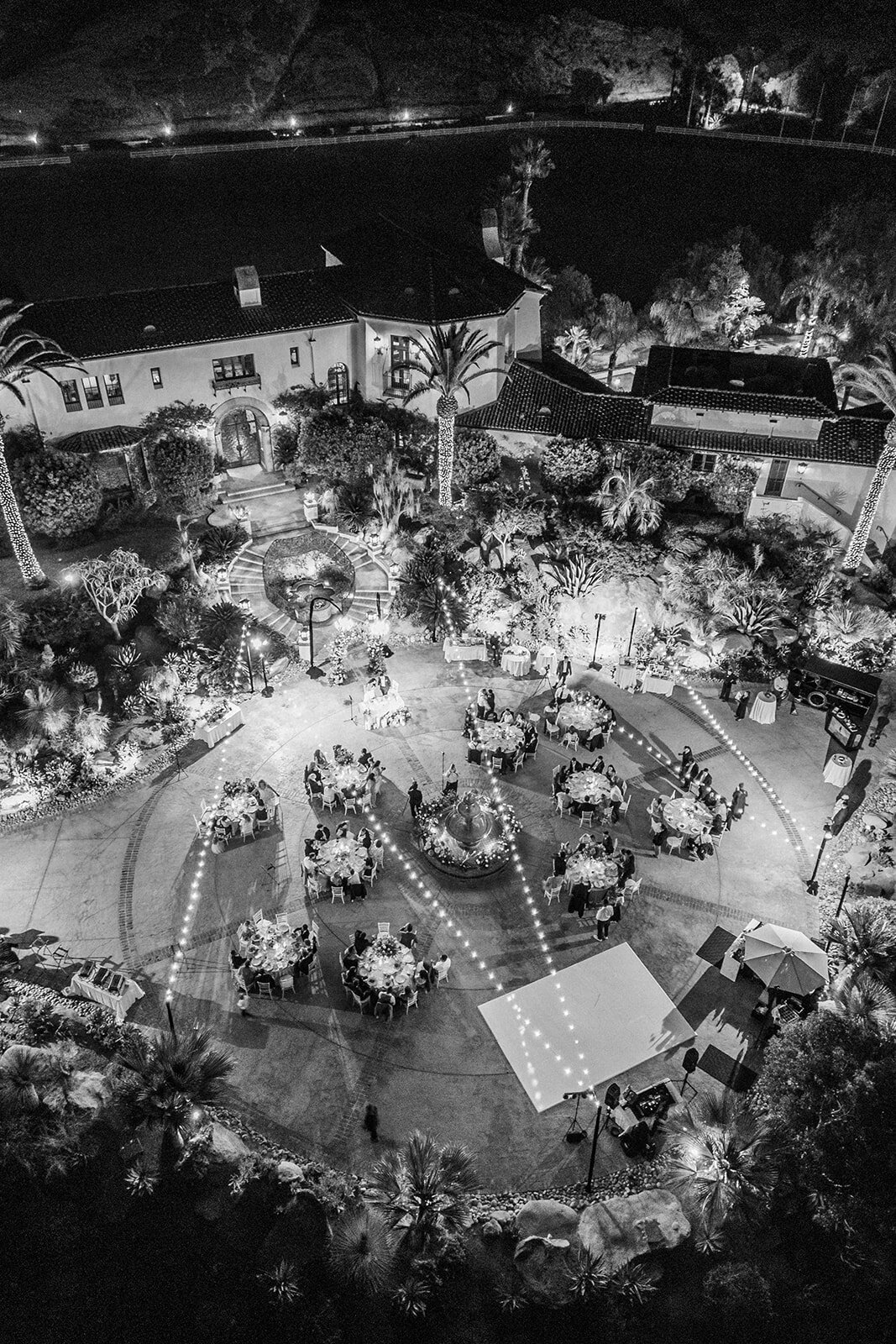Black and white film photo of packed dance floor at a wedding reception in Los Angeles, captured in authentic documentary style.