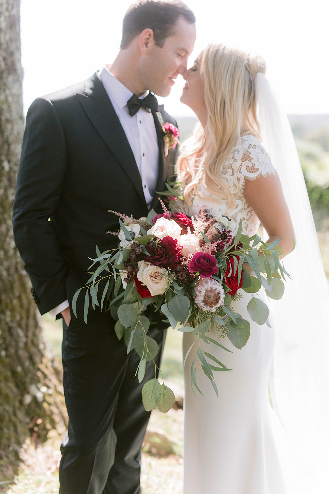 Burgundy bridal bouquet with bride and groom at montaluce winery and restaurant