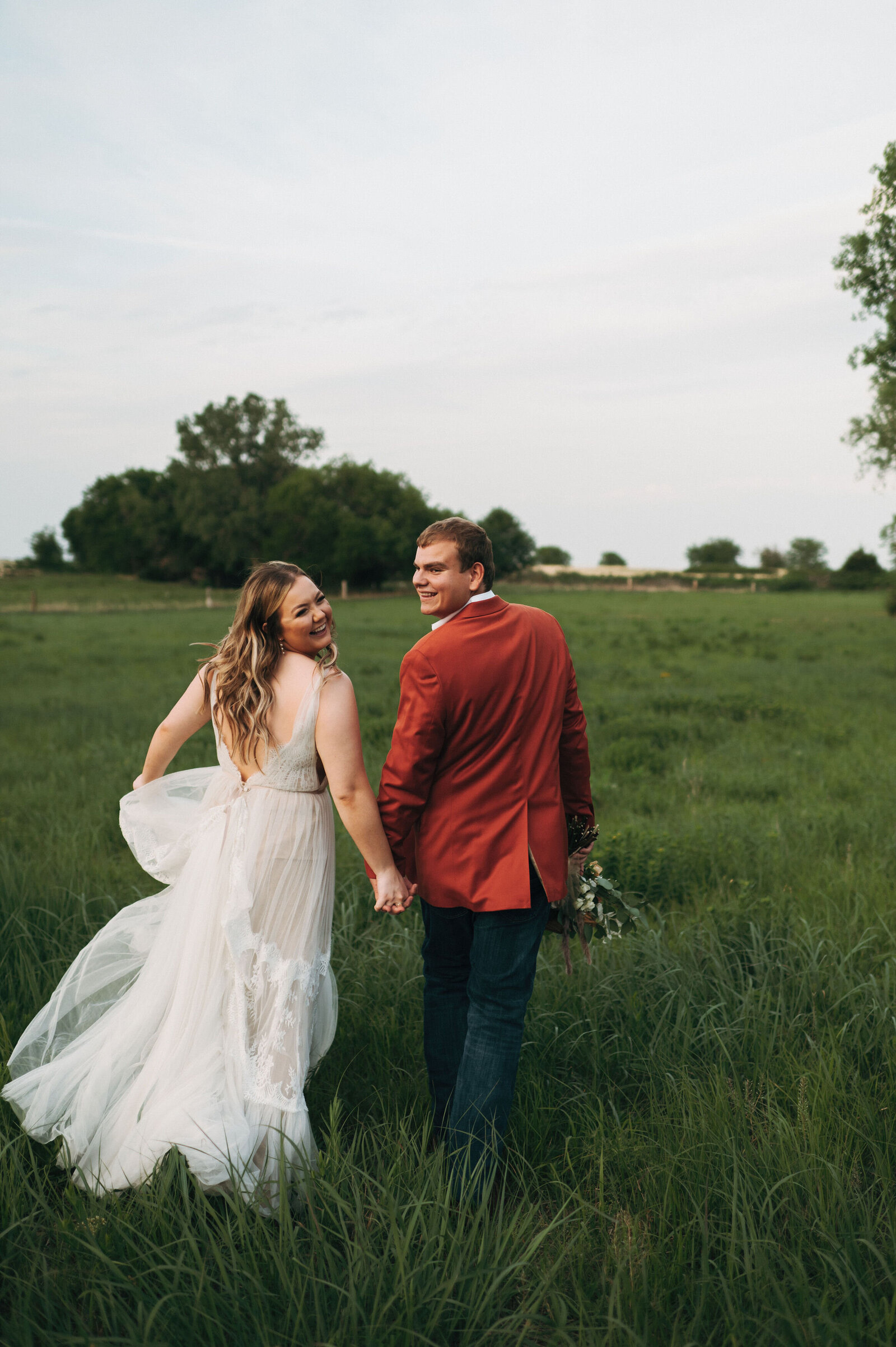 Bride and Groom running in a field during sun set photos