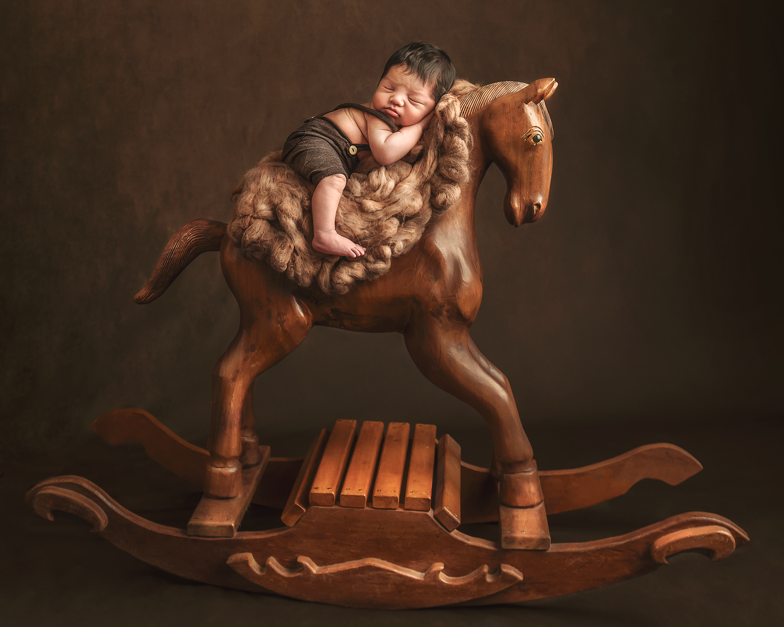 Baby-on-a-wooden-horse-portrait