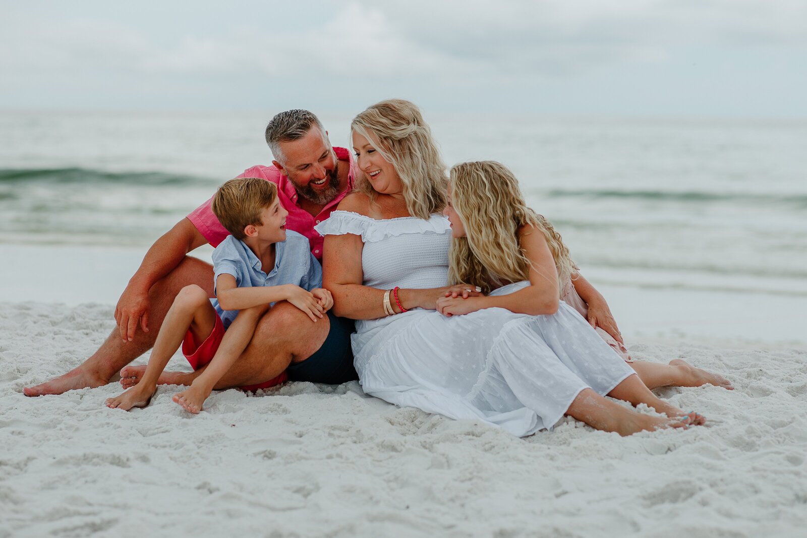 Pensacola Beach vacation family photography session .  Family  playing on the beach.