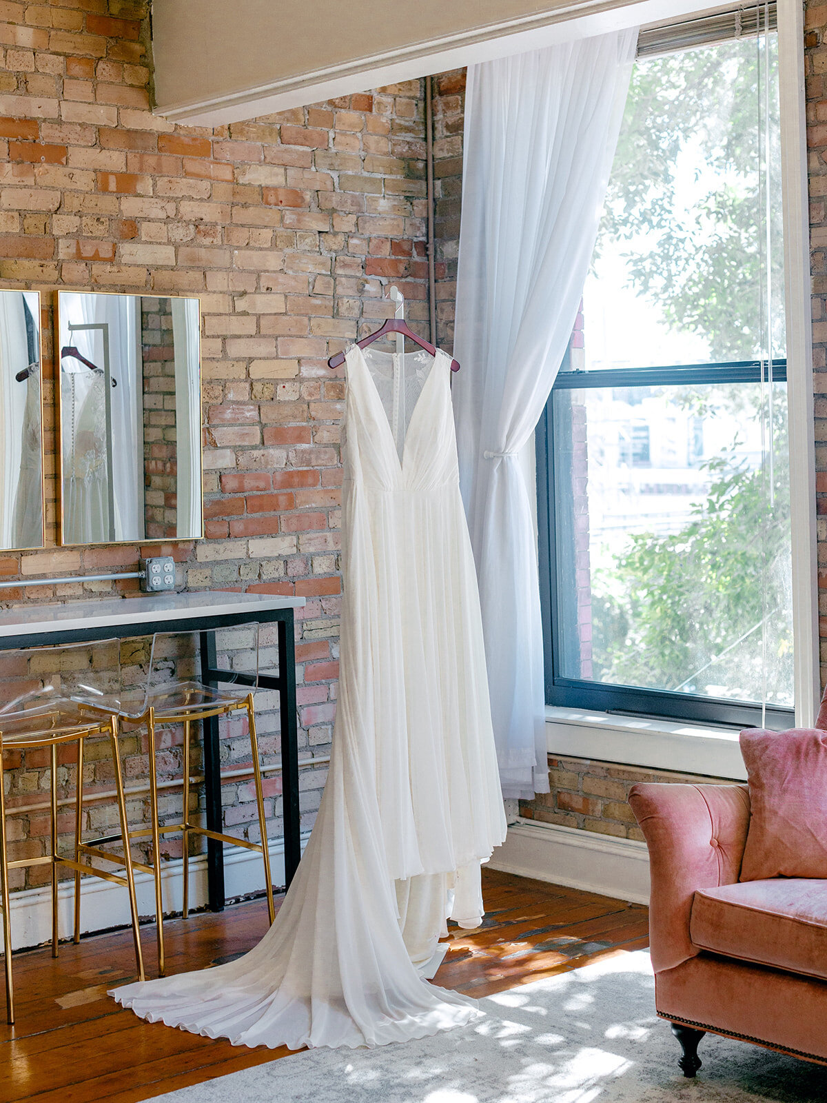 bride-wedding-dress-hanging-brick-wall