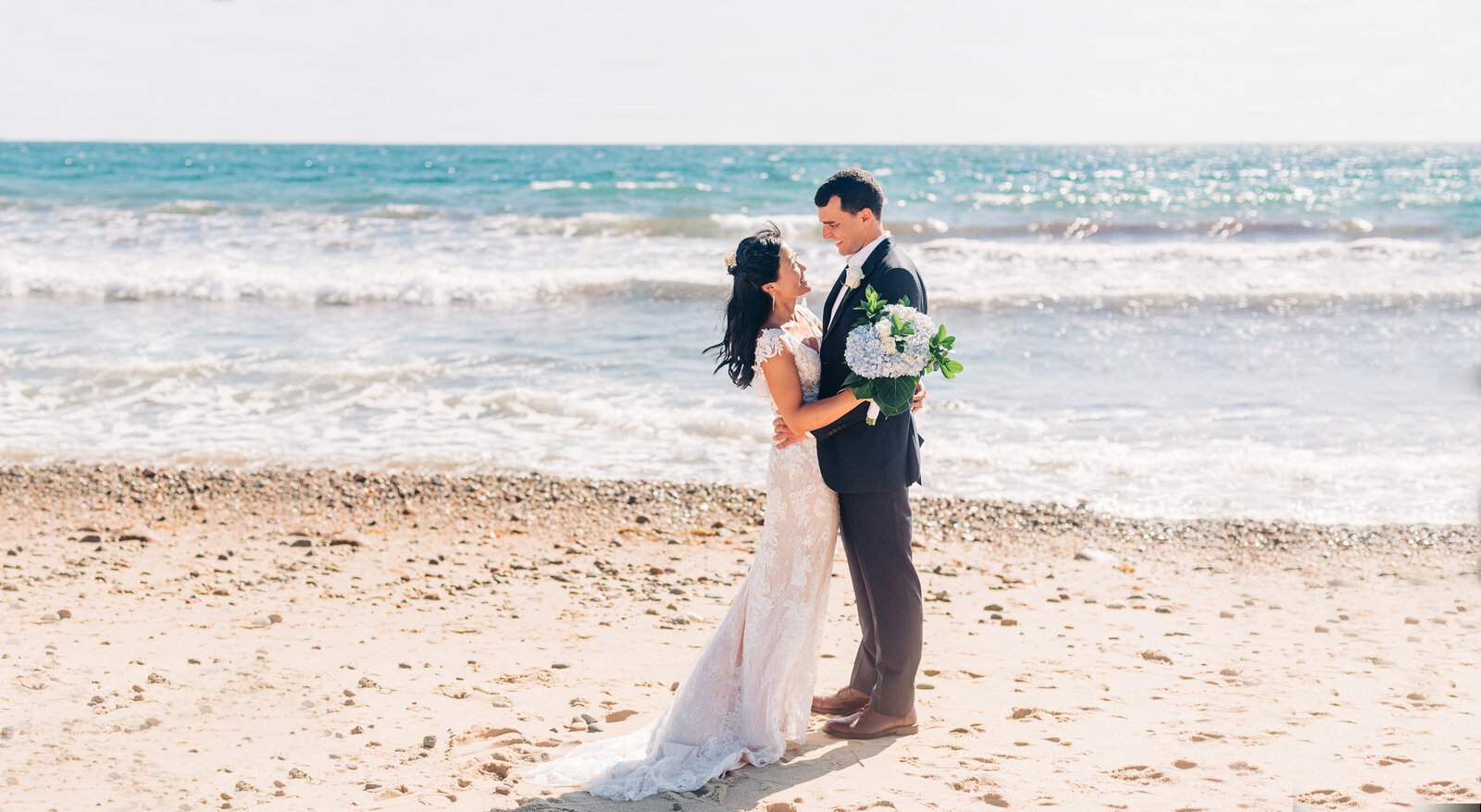 wedding couple standing on the beach