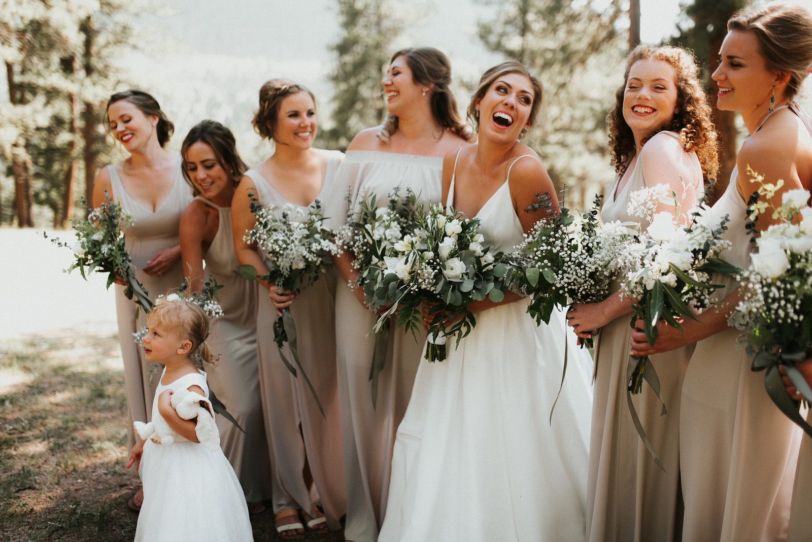 bride laughing with her bridal party