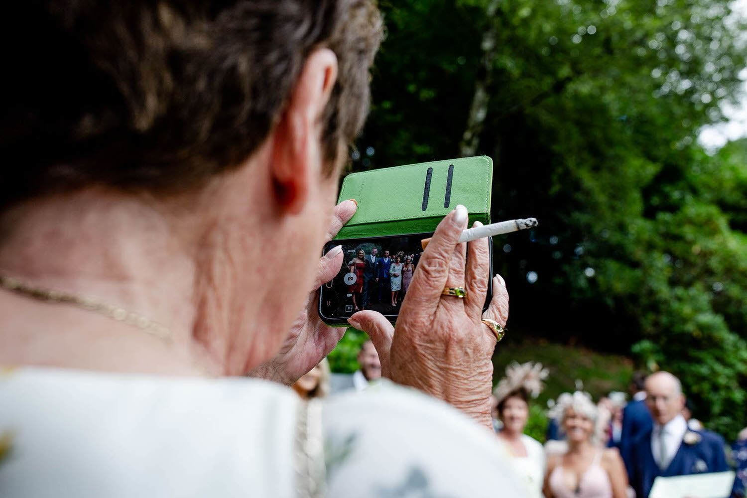 gran takes a family wedding photograph on her phone