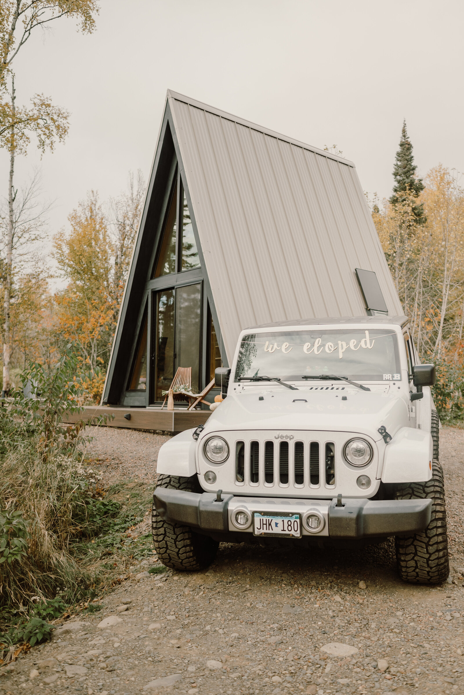 wrangler jeep park by a-frame cabin in PNW