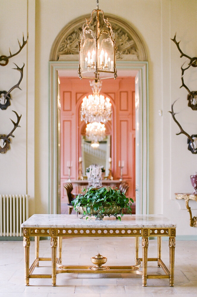 Reception room at a chateau with marble top table and gold legs