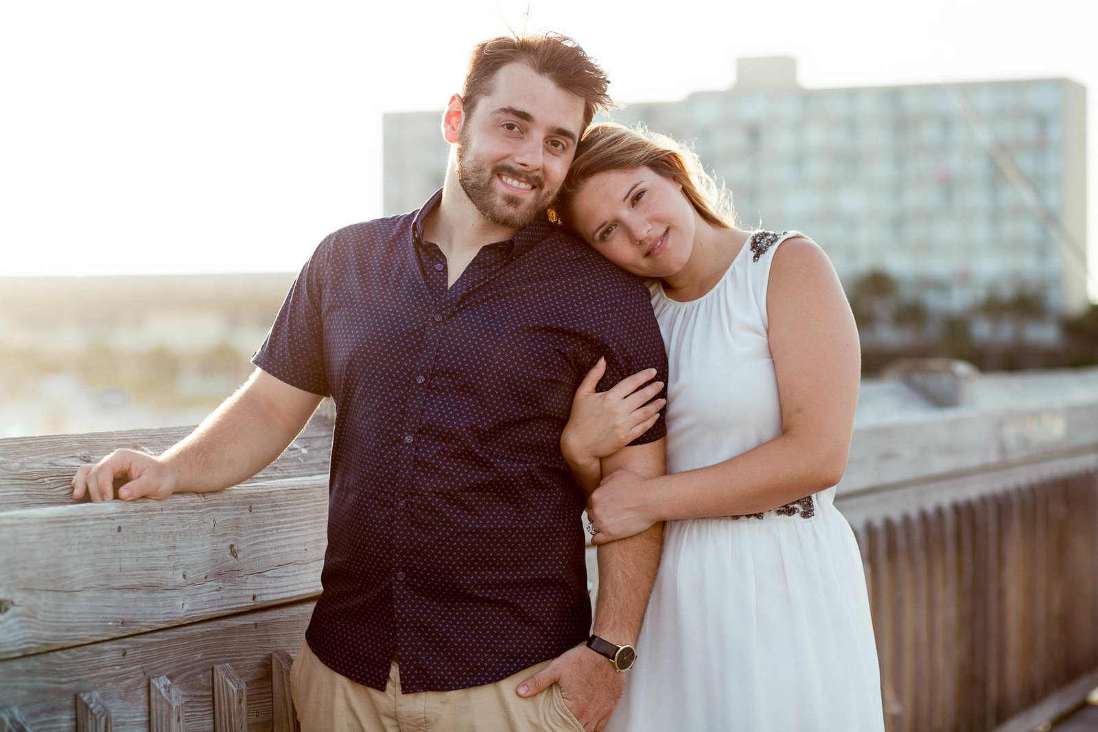 Engaged Couple at sunset on pier, Folly beach in Charleston, South Carolina