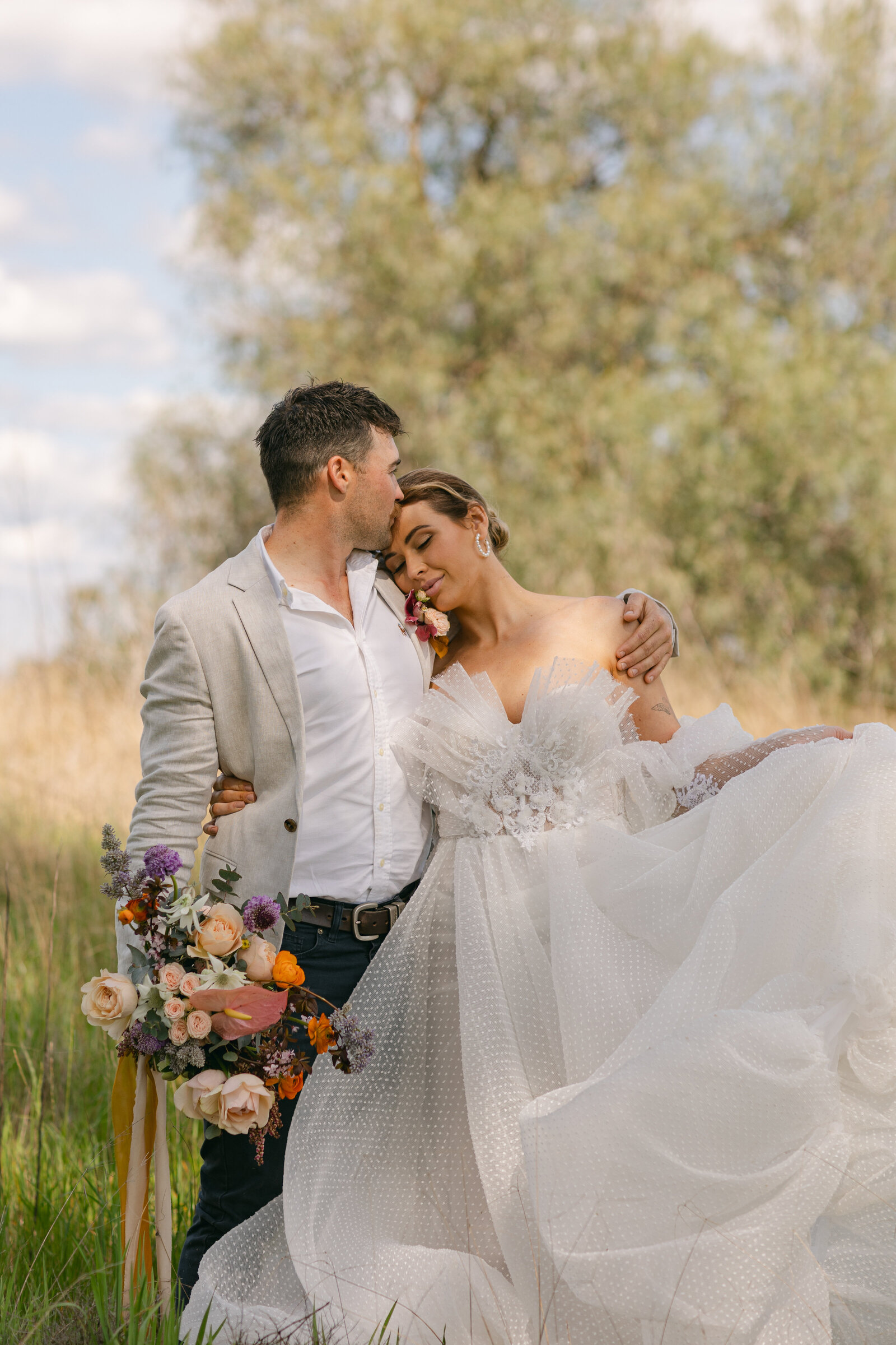 bride and groom in long grass