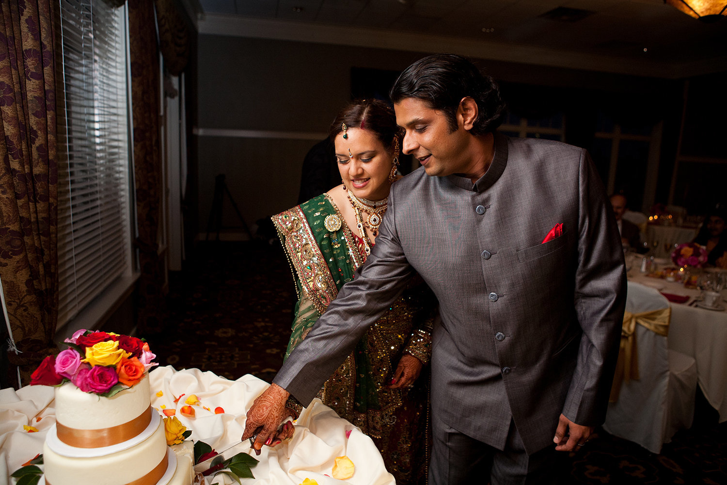 Indian bride and groom cut their cake