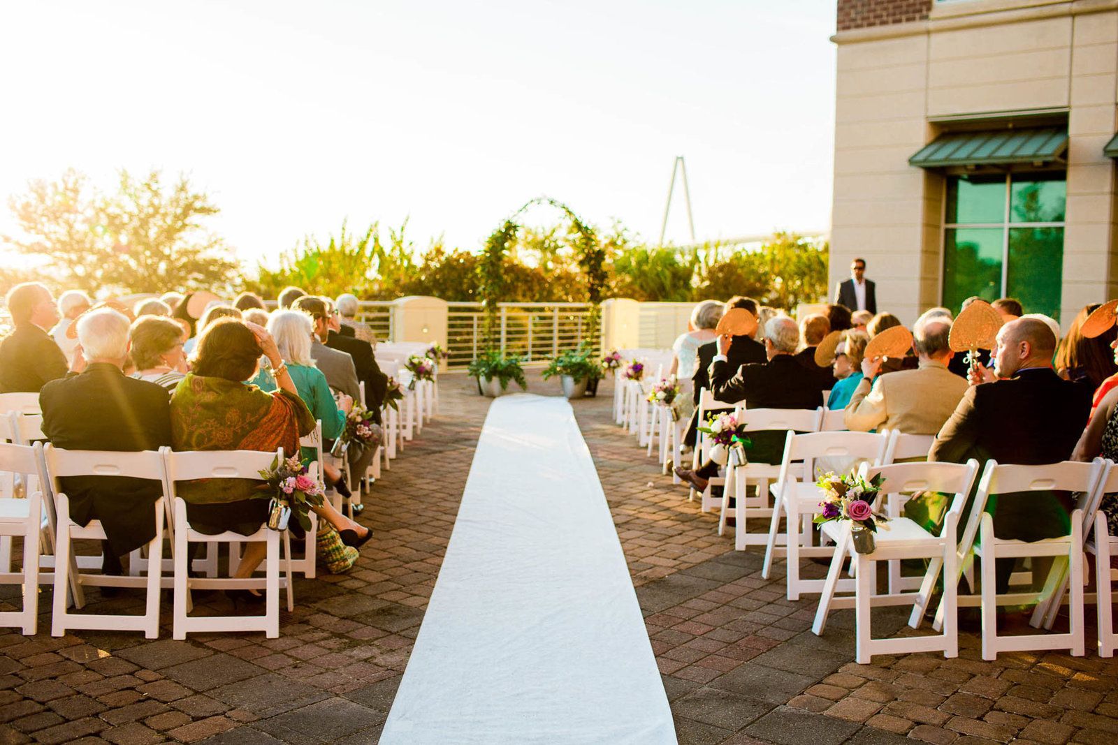 Ivy covered arch are at center of the aisle, Harborside East, Charleston Wedding Photography.
