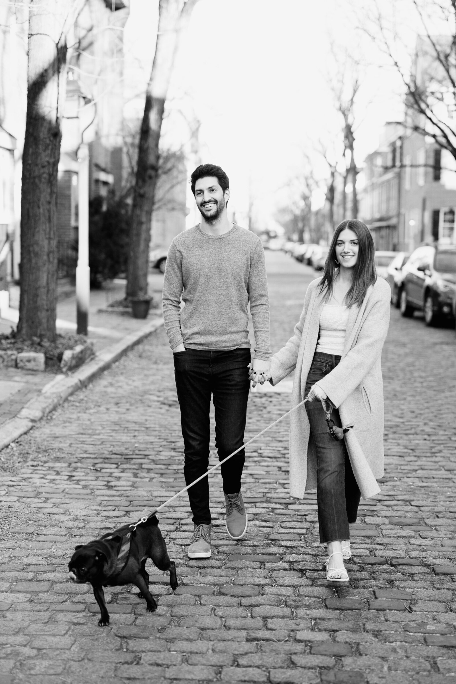 couple in city street with dog