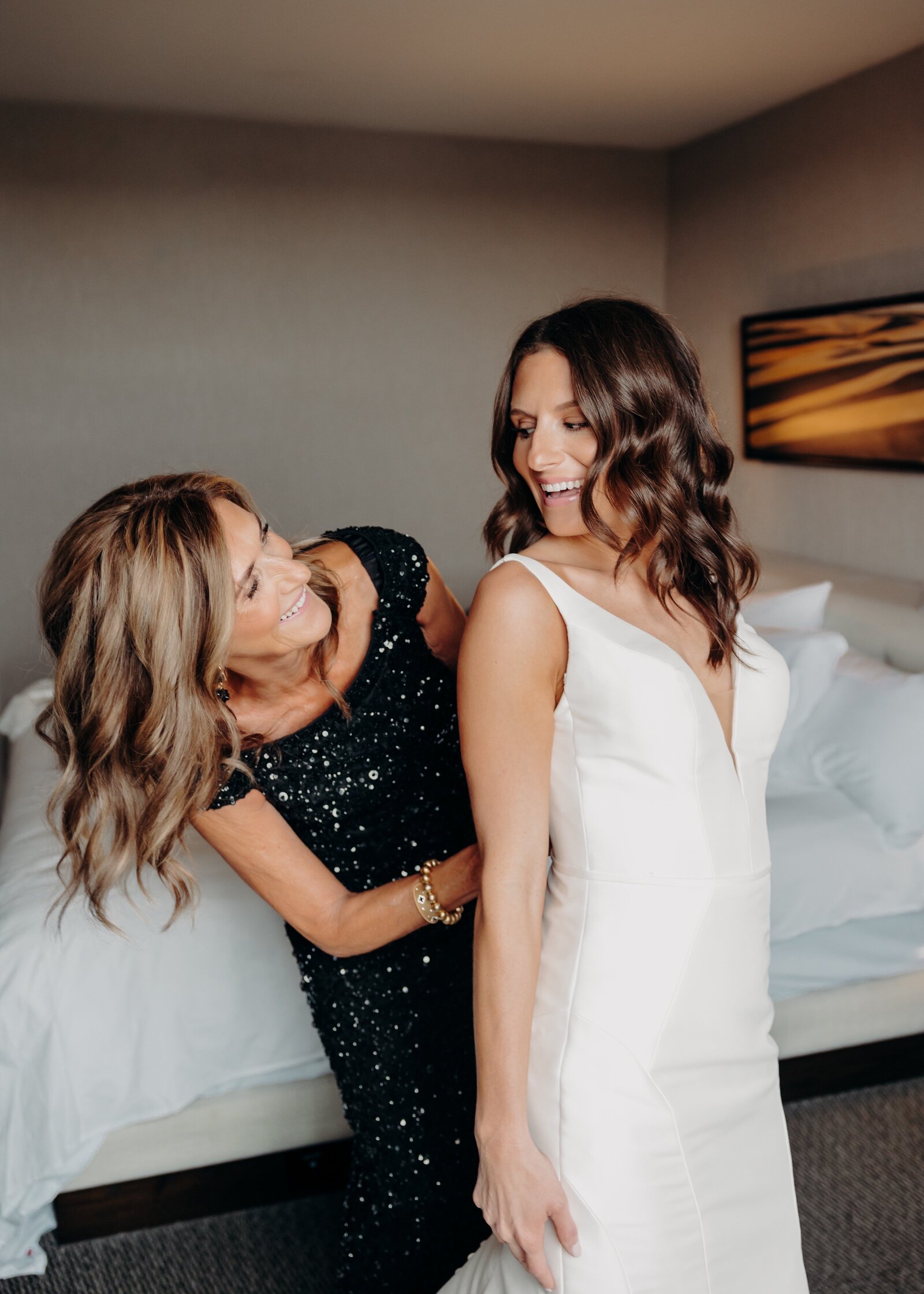 Mother helping bride get dressed at The Hyatt in downtown Wichita - Katy Elaine Photography