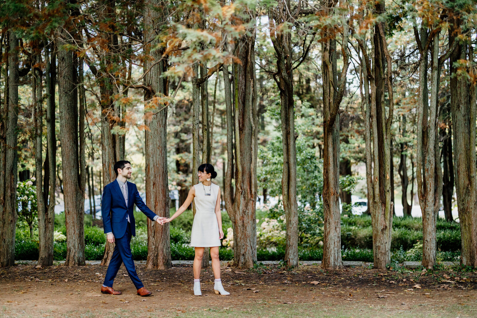bride in short dress with groom in woods
