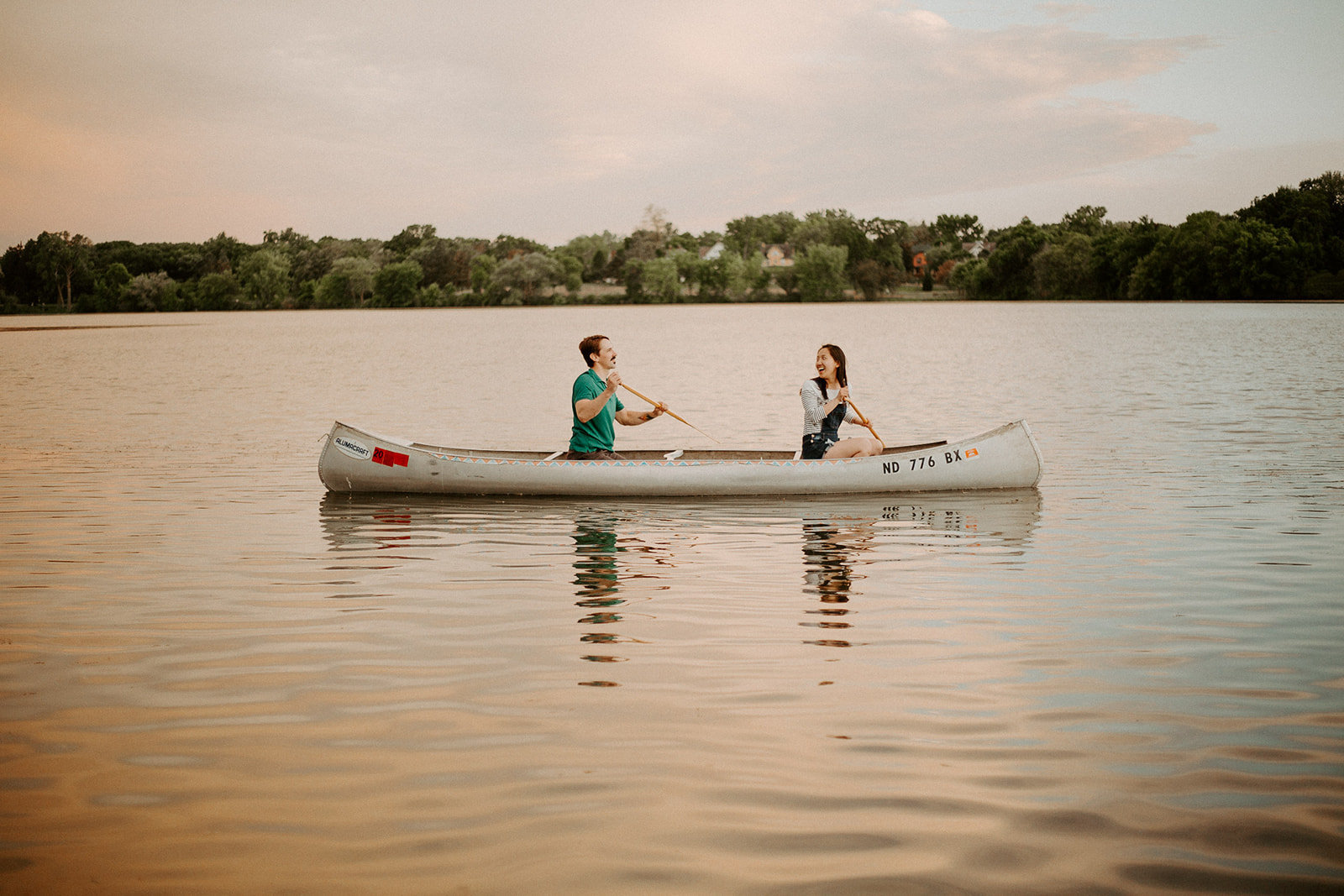 Couple in a canoe on the lake during their Minneapolis engagement session