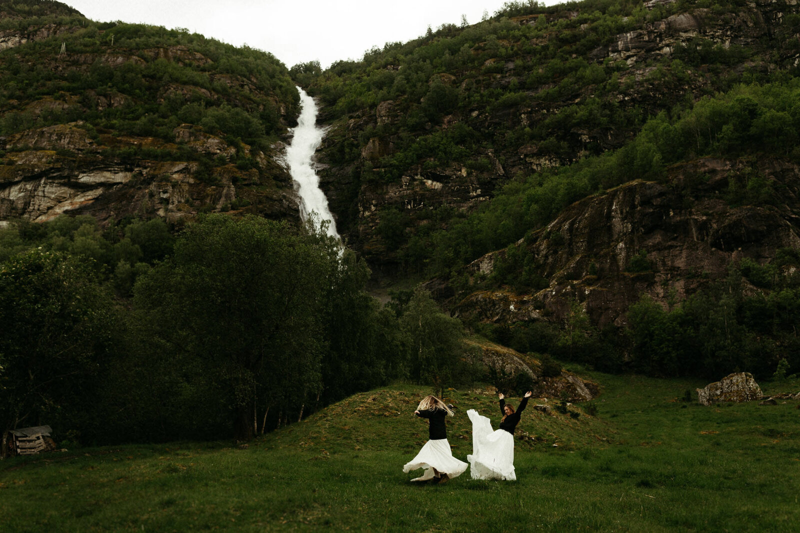 brides in norway at waterfall running around