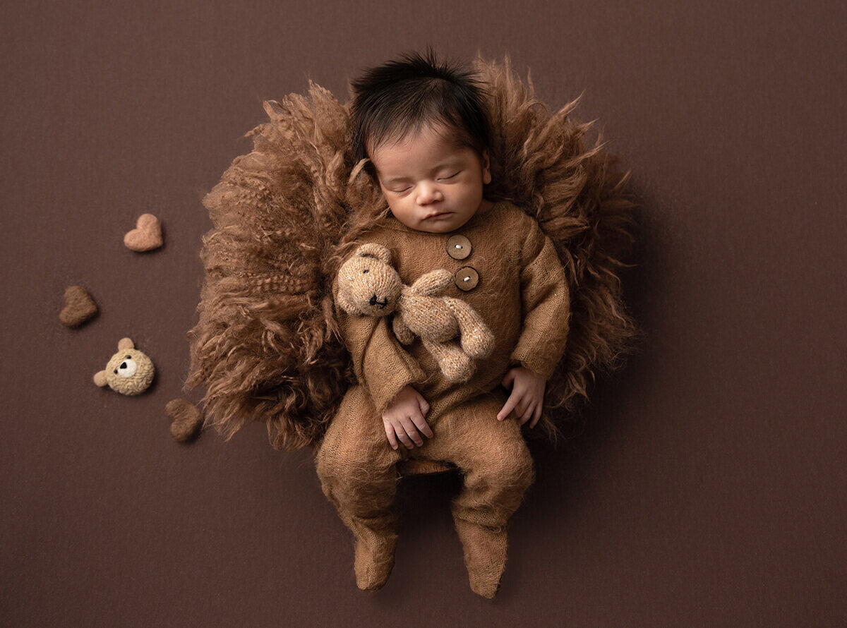 a baby dressed as a teddy bear