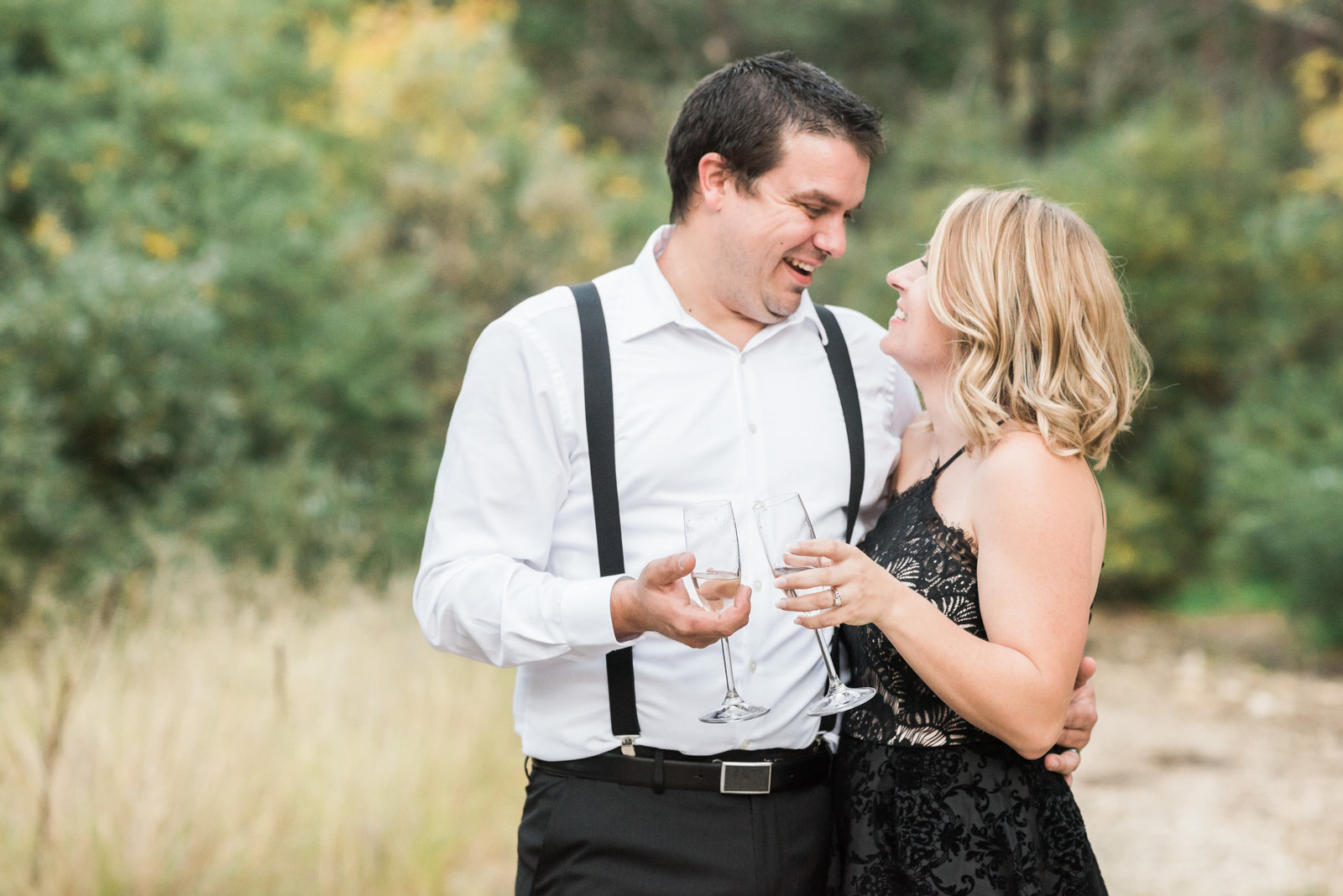 Mt Lemmon Classy and Stylish Engagement Session Photo of Engaged Couple and Champagne Glasses Toasting | Tucson Wedding Photographer | West End Photography