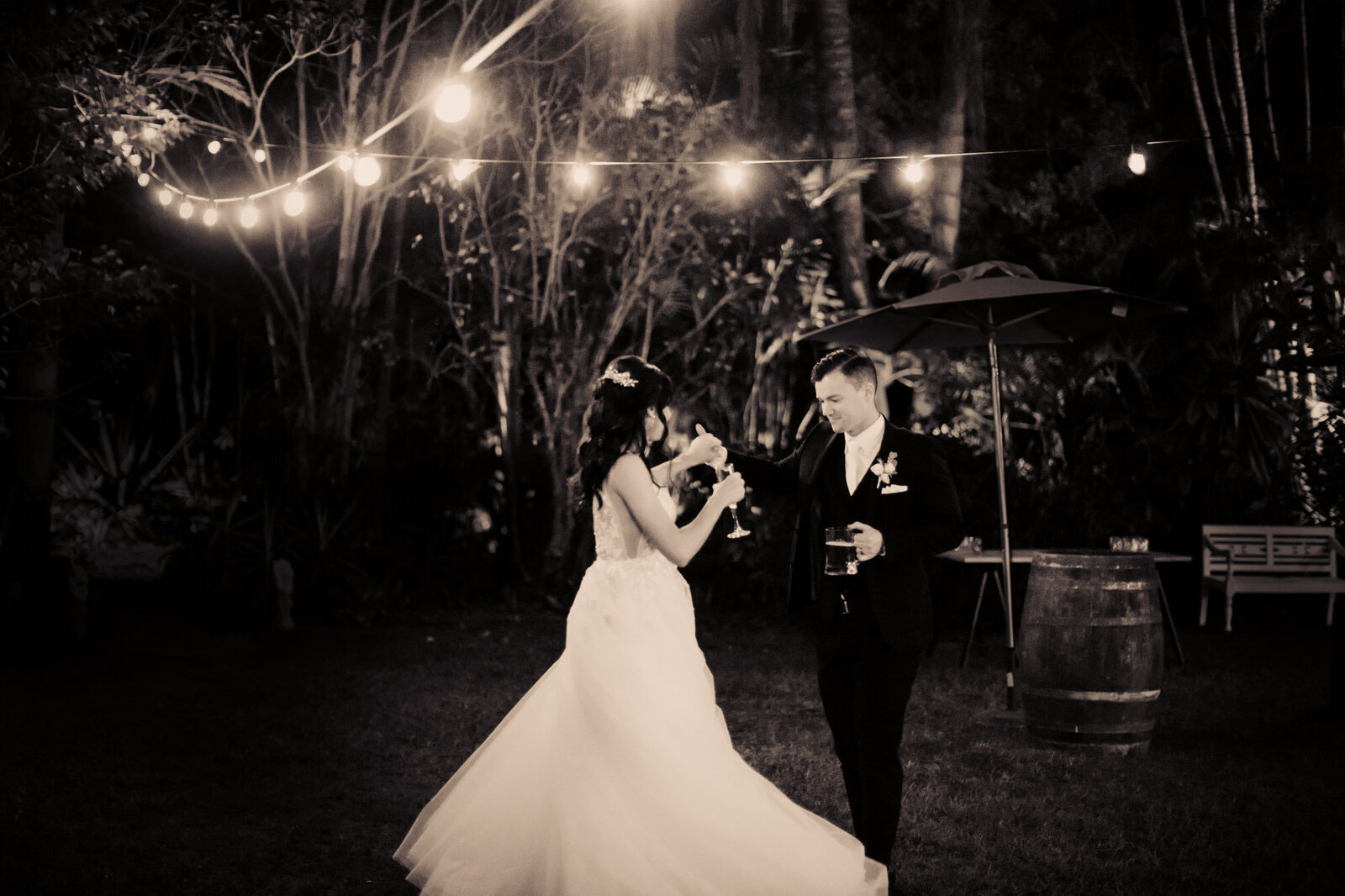 Wedding couple dancing while having champagne
